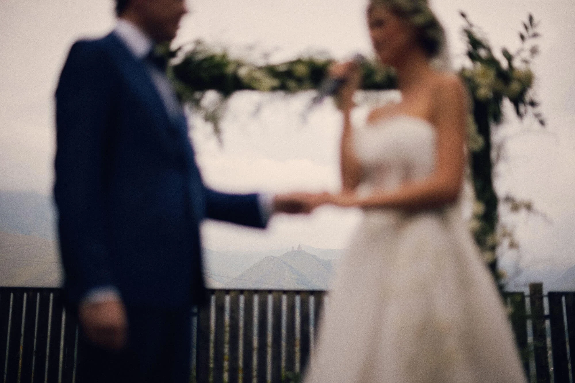 Groom holding bride’s hands during vows