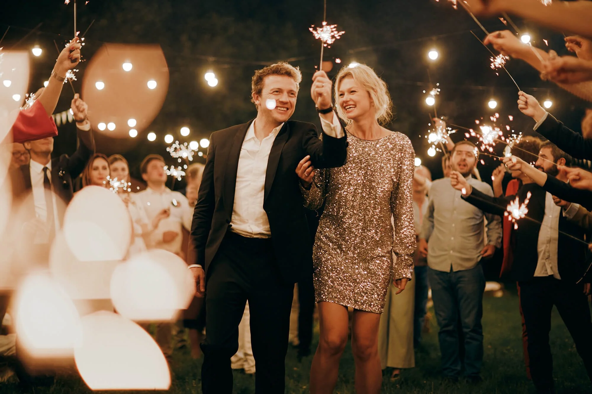 Couple laughing during sparkler exit