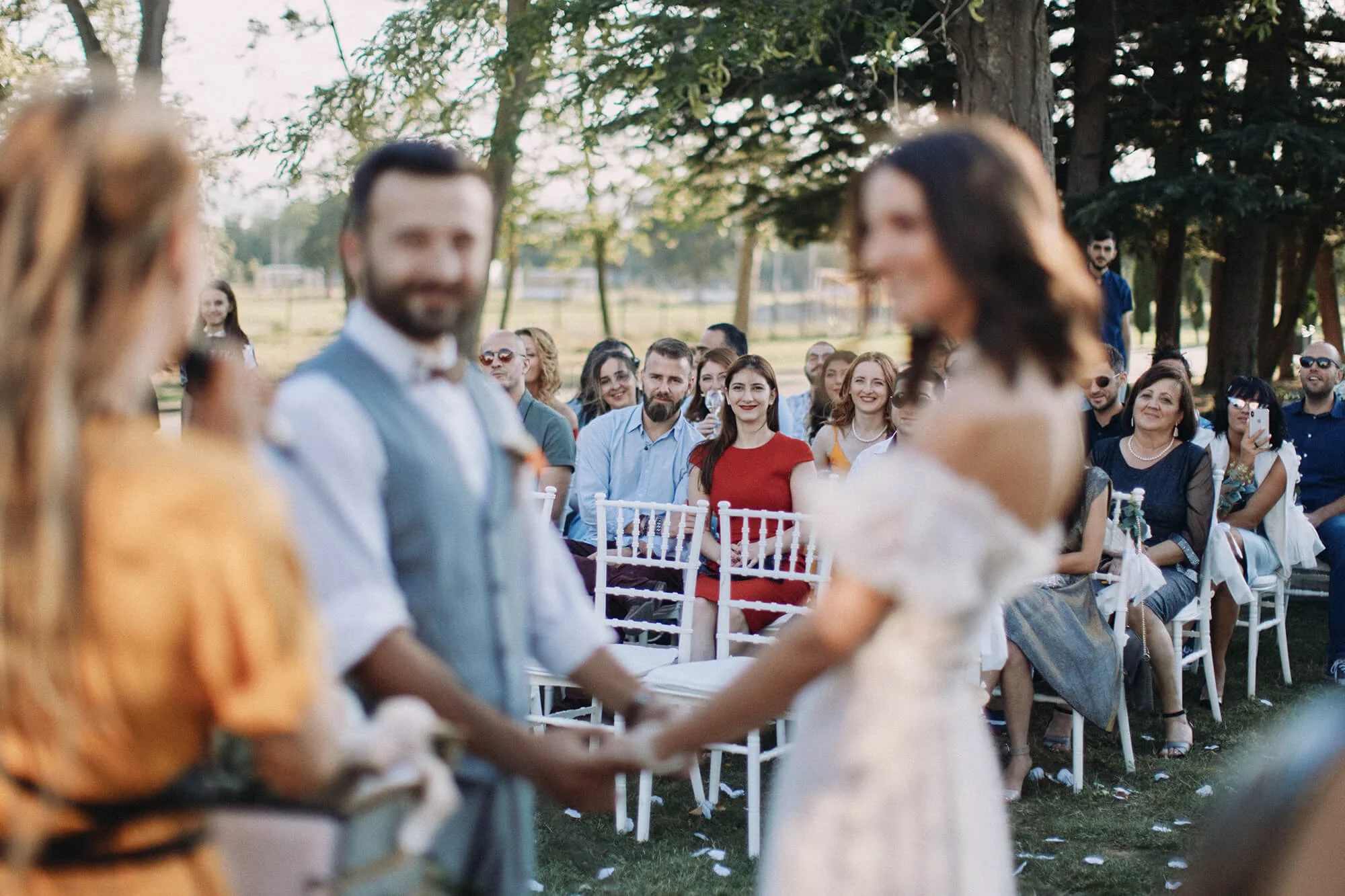 Guests watching the ceremony outdoors at sunset