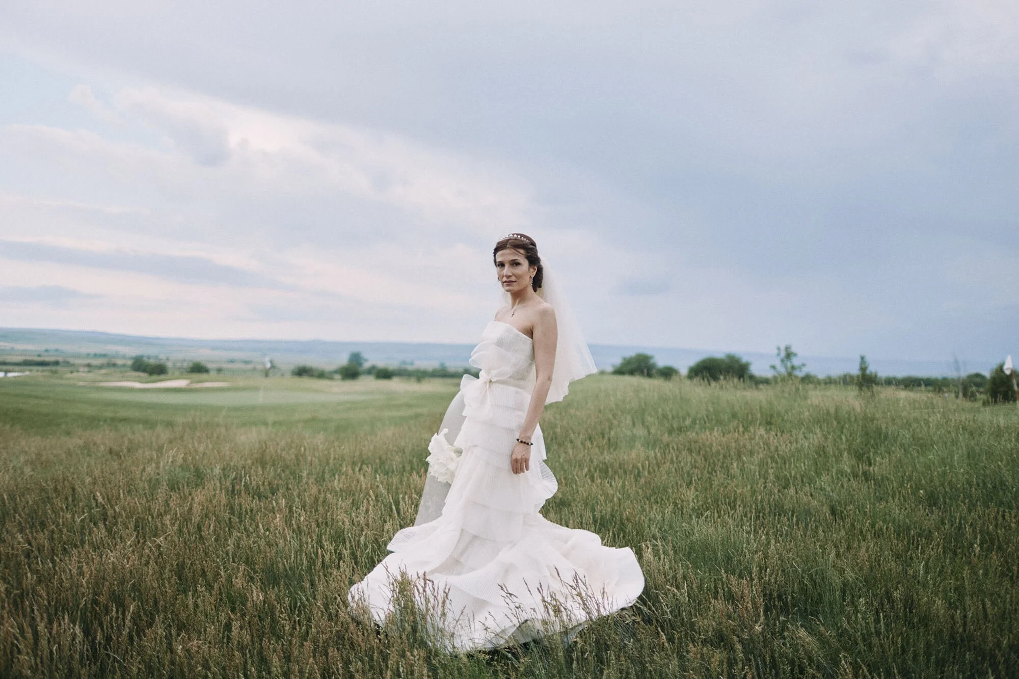 Elegant bride posing outdoors for wedding portrait