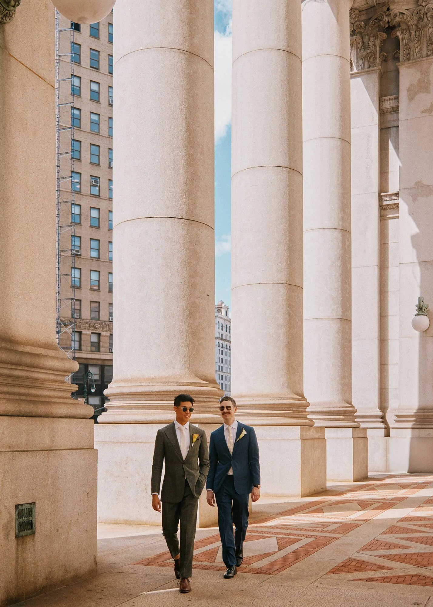 Newlyweds enjoying a stroll around City Hall after wedding