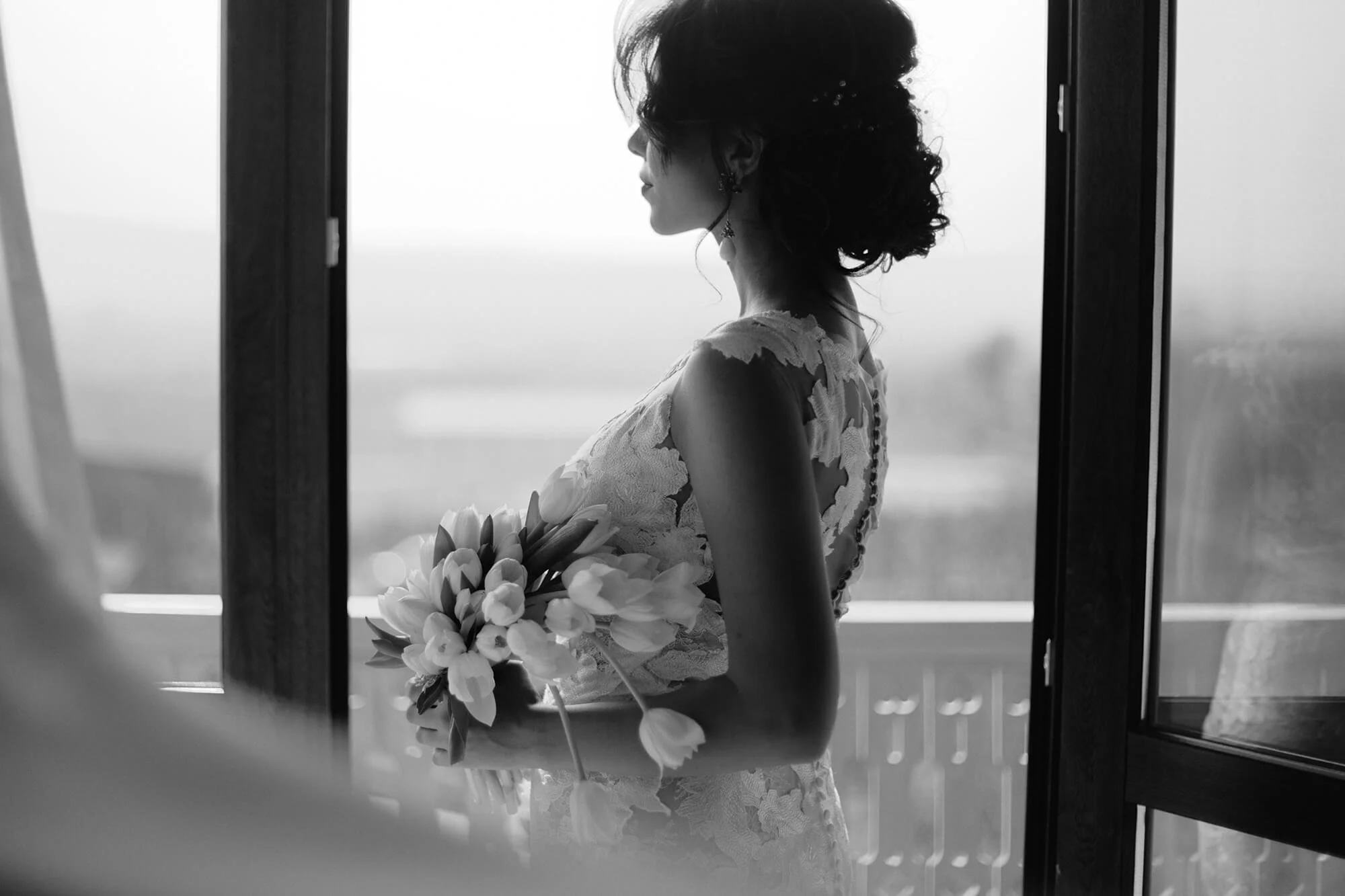 Bride holding bouquet in black and white portrait