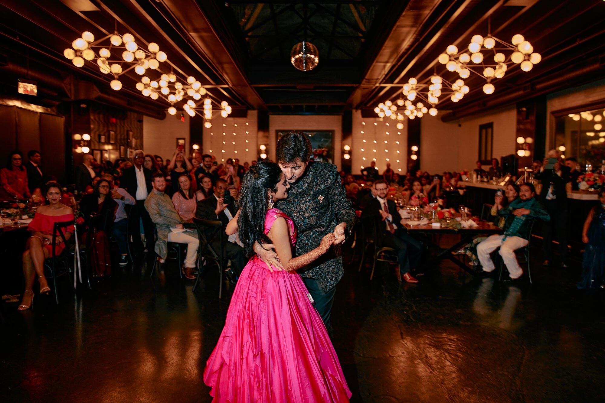 The couple’s first dance at their vibrant fusion wedding reception
