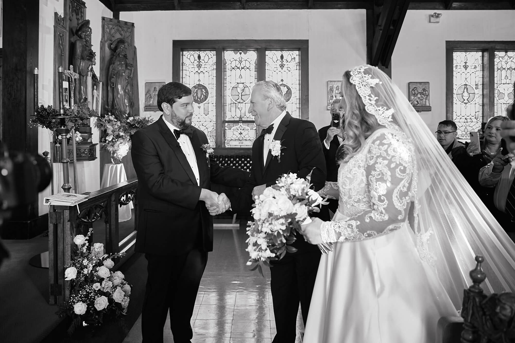 Bride handed to groom by her father