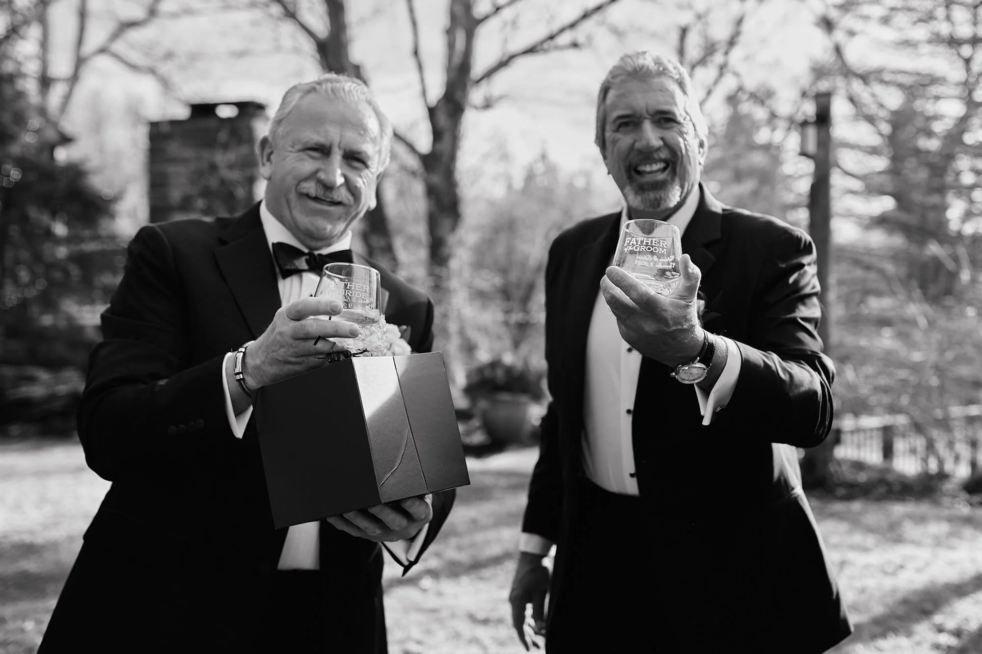 Father opening the gift with a joyful reaction before the ceremony