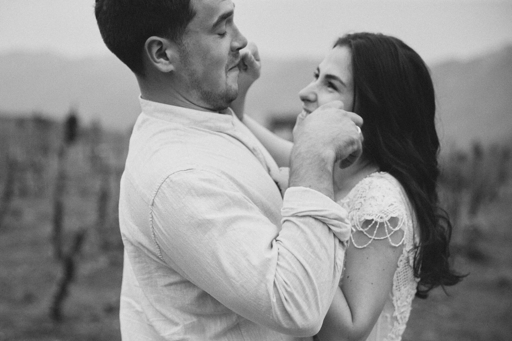 Newly engaged couple laughing while playfully teasing each other