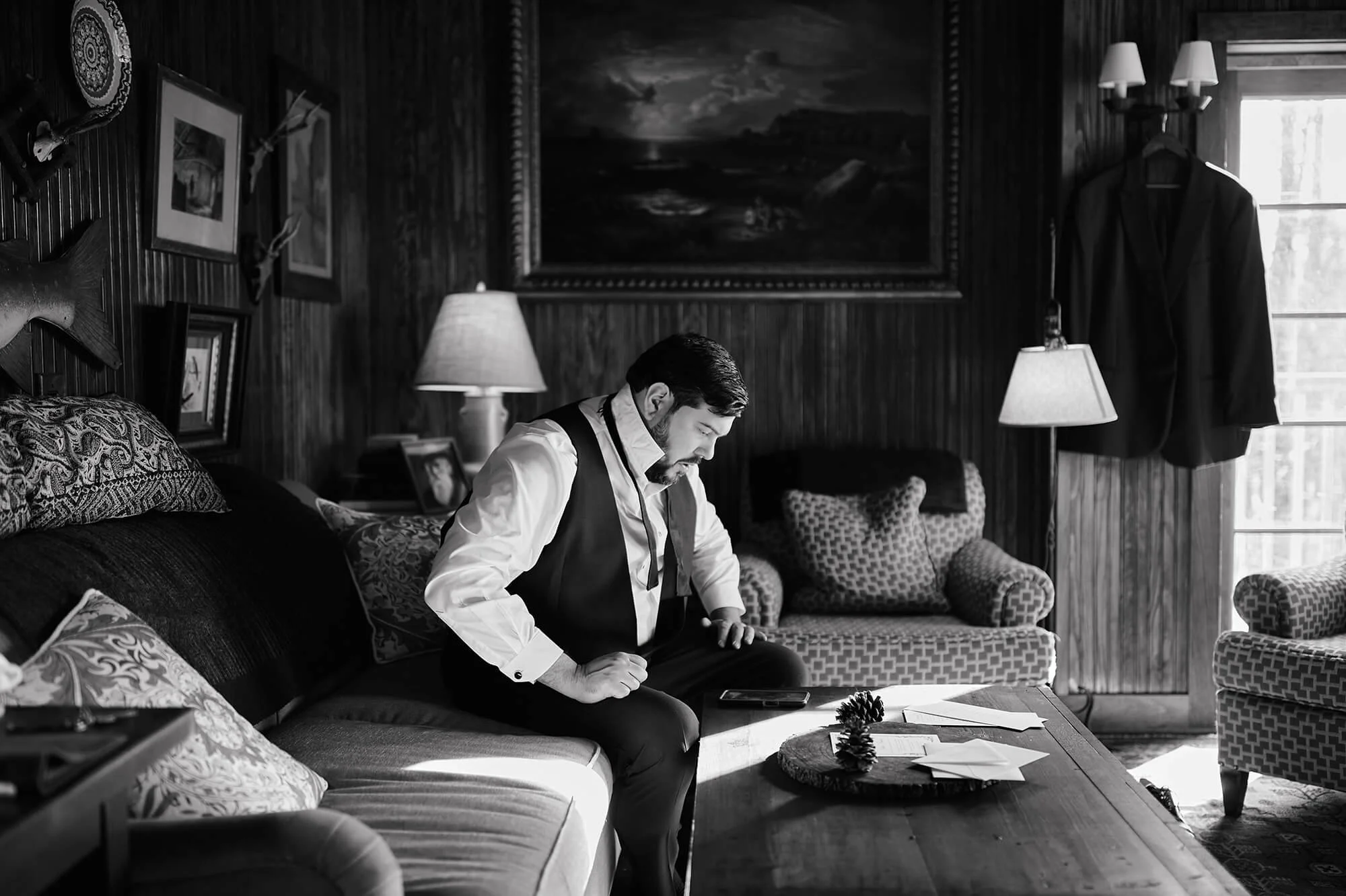 Groom writing vows in rustic room