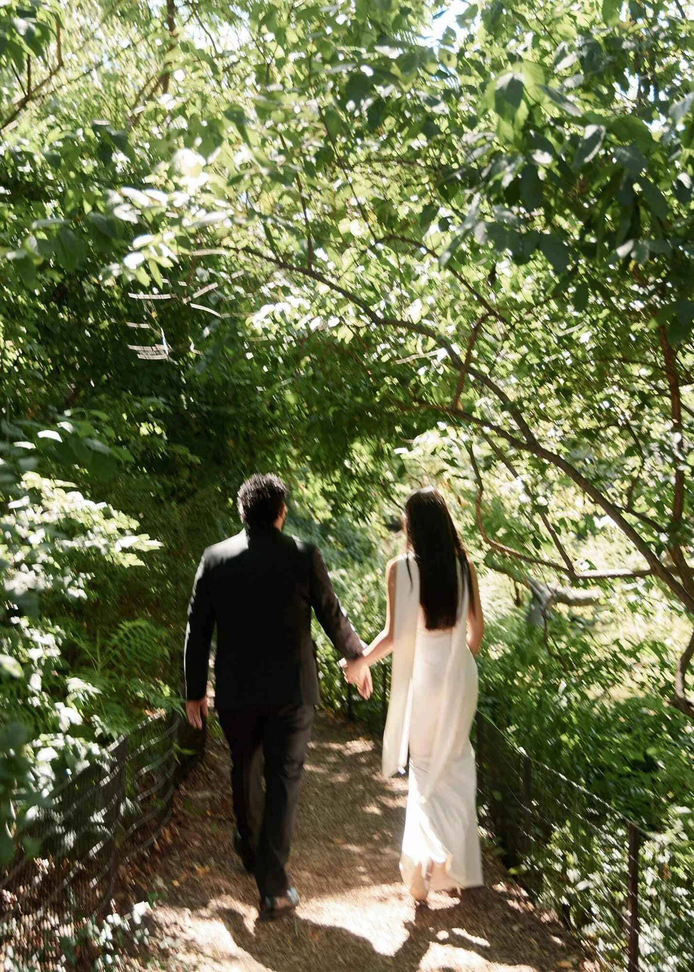 Engaged couple walking together in Central Park during their NYC engagement session