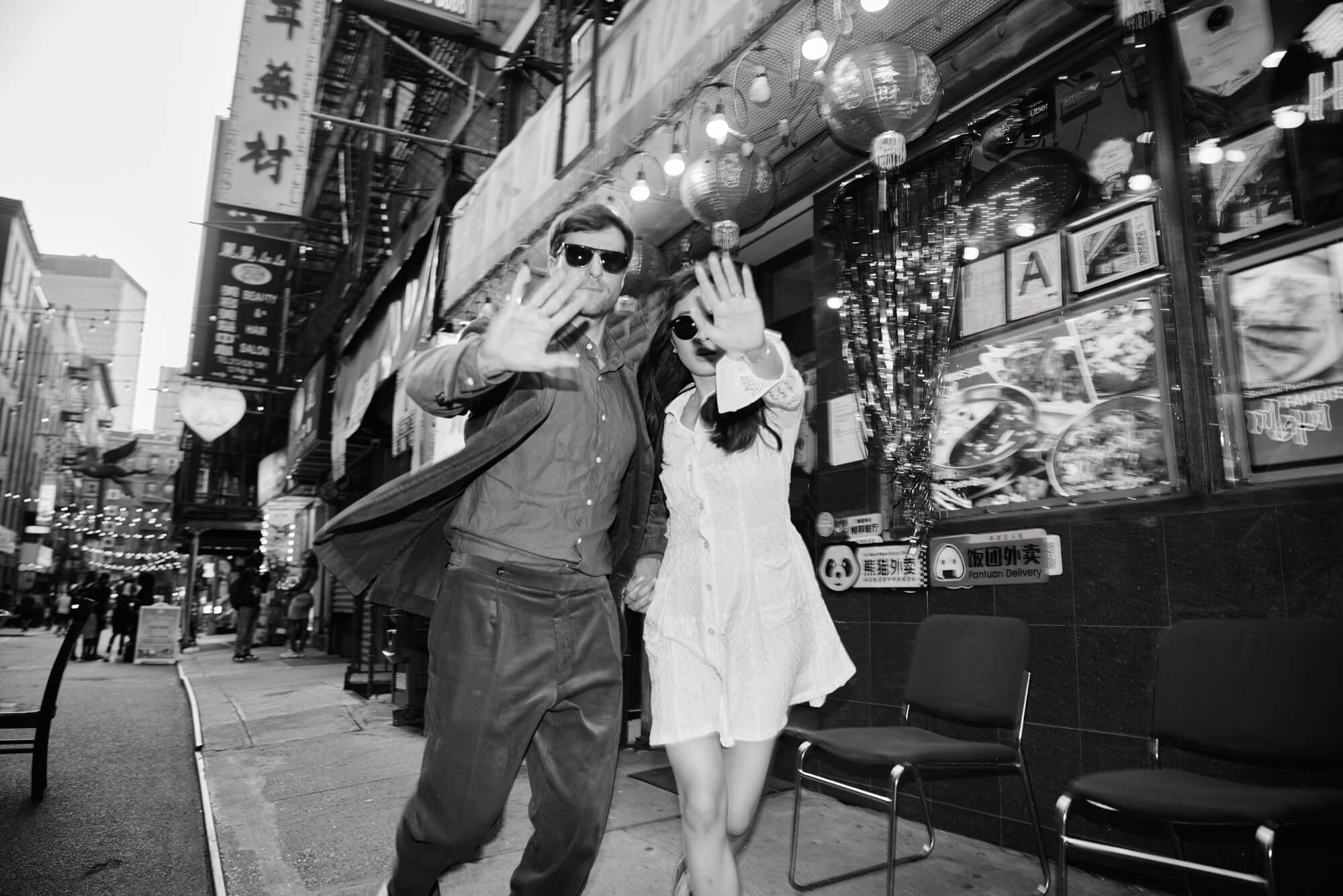 Newly engaged couple playful paparazzi moment in Chinatown