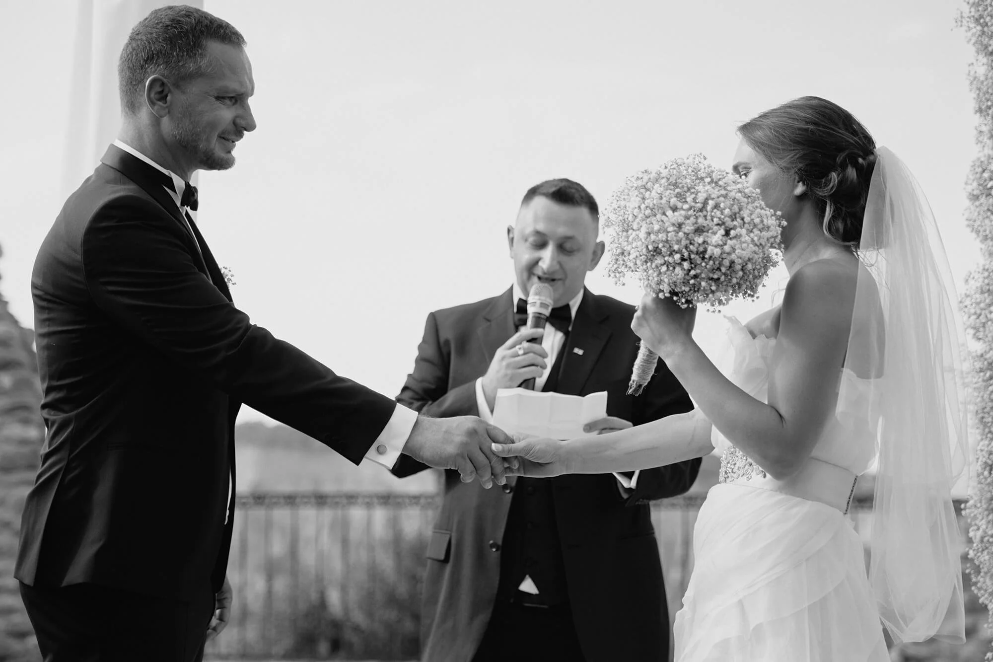 Bride and groom holding hands while exchanging vows