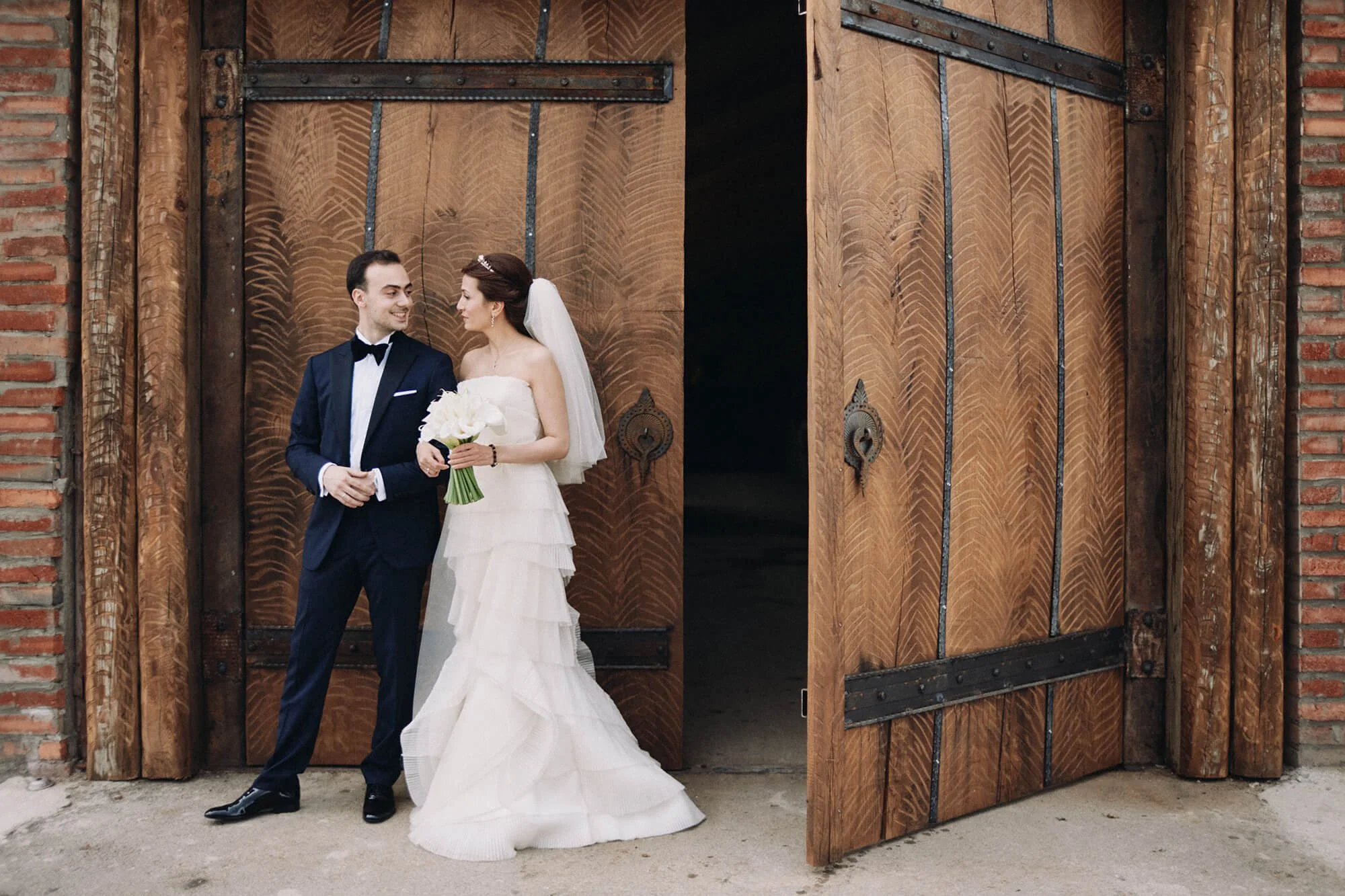 Romantic couple enjoying a candid moment near barn