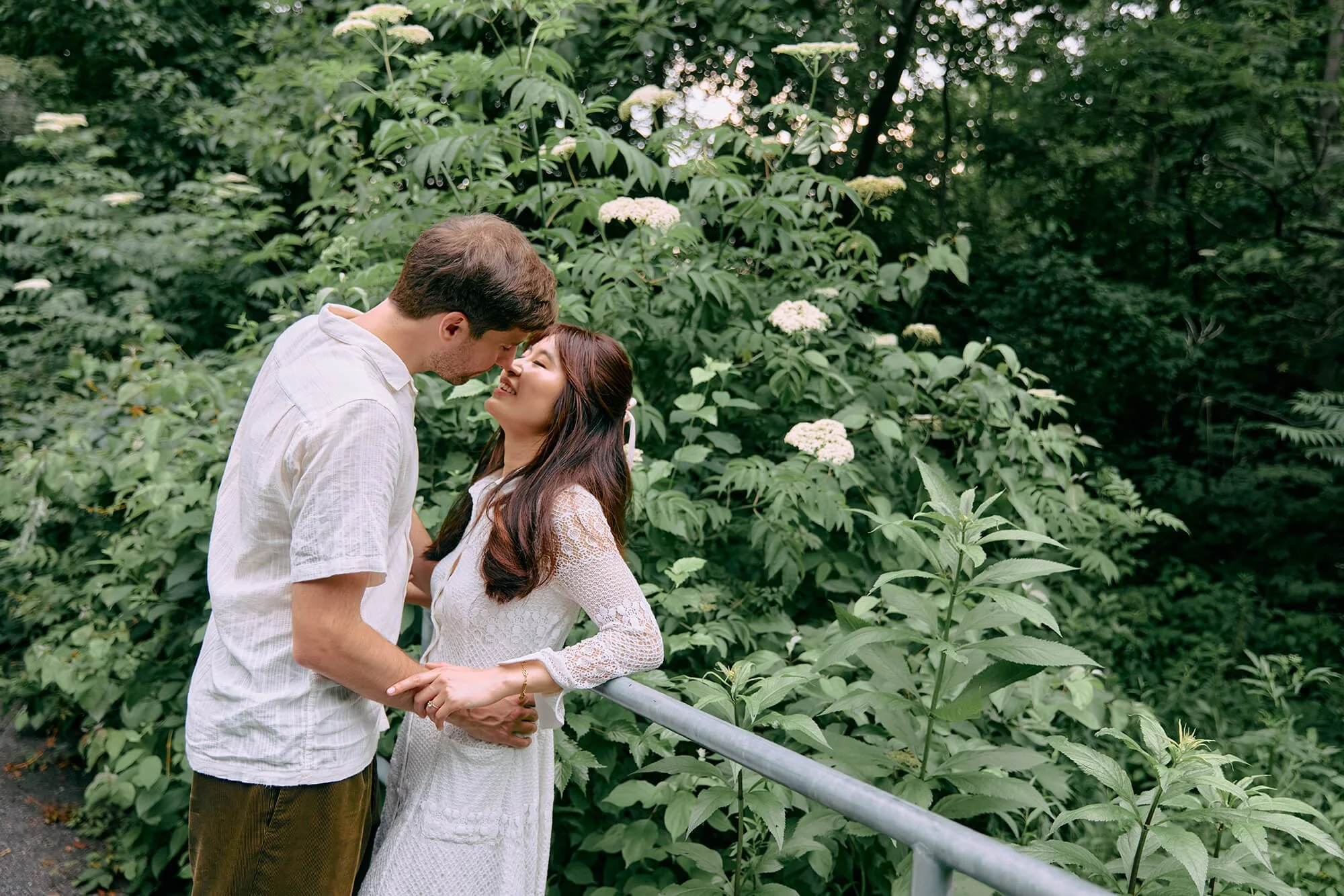Newly engaged couple sharing an intimate moment in Dumbo