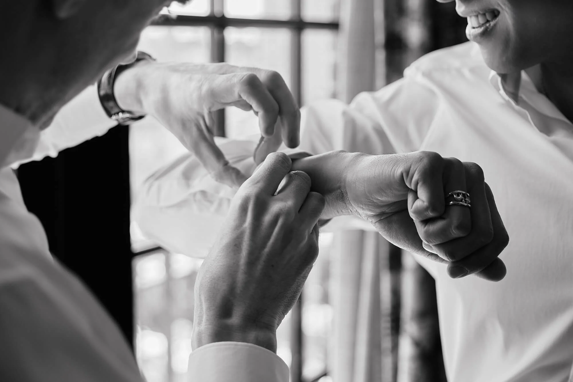 Detailed shot of couple doing cufflinks at Ludlow Hotel NYC