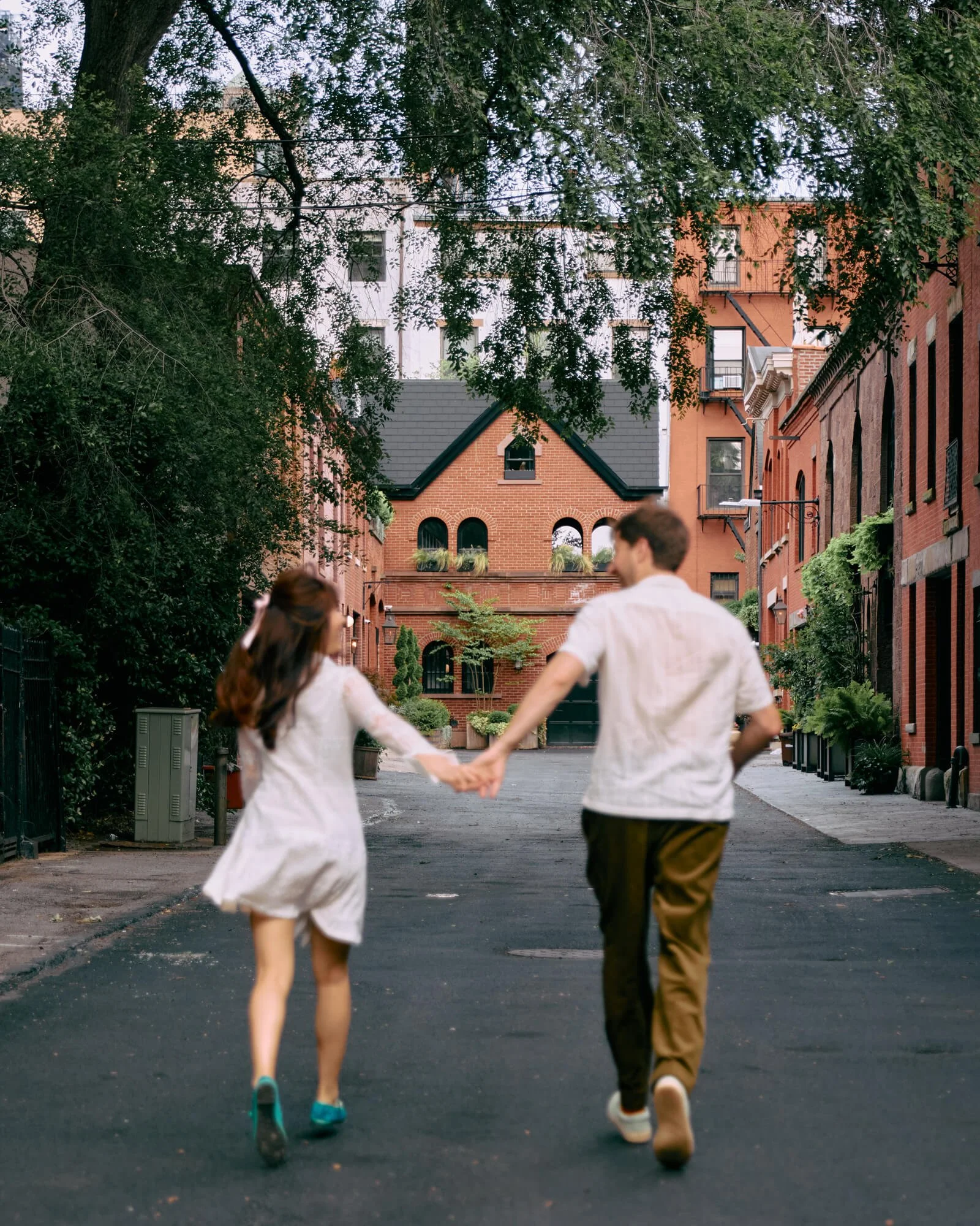 Romantic couple running through Brooklyn Heights streets