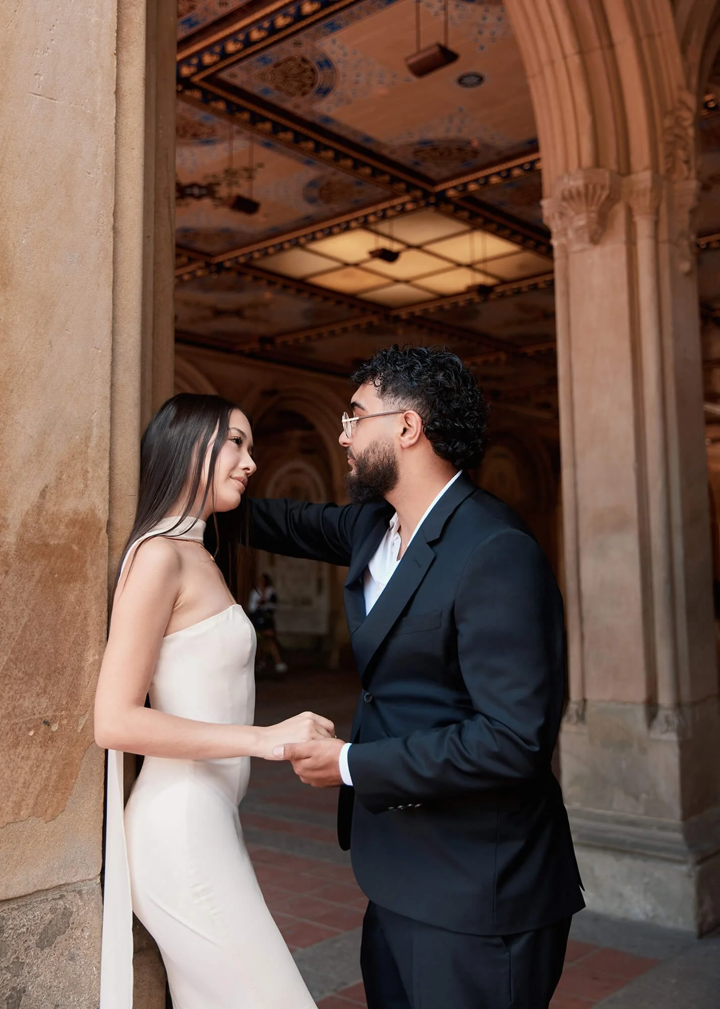 Intimate Central Park engagement photo with couple leaning in for a kiss