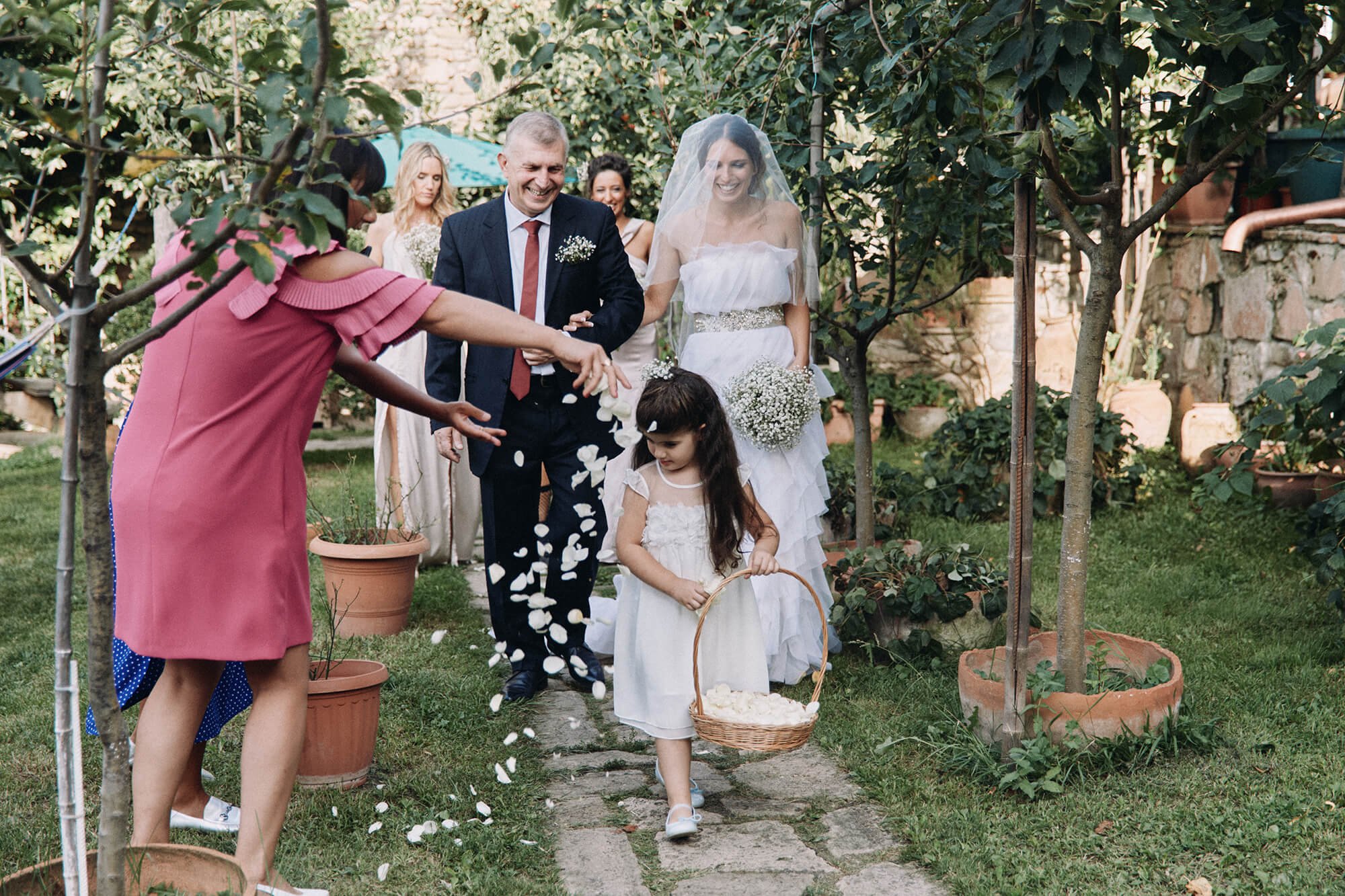 Emotional aisle walk with father escorting bride and flower girl