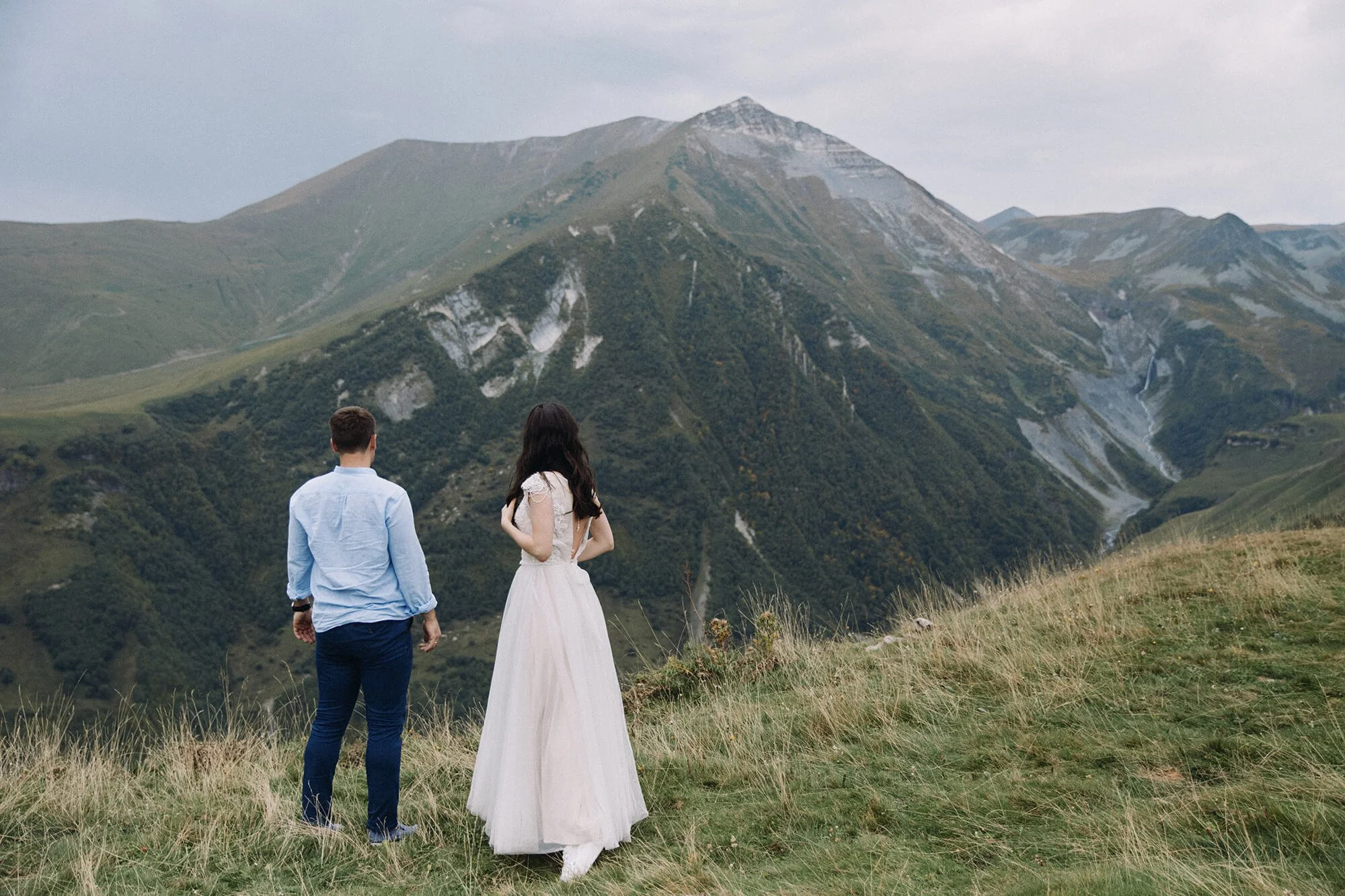 Romantic engaged couple taking in breathtaking mountain view