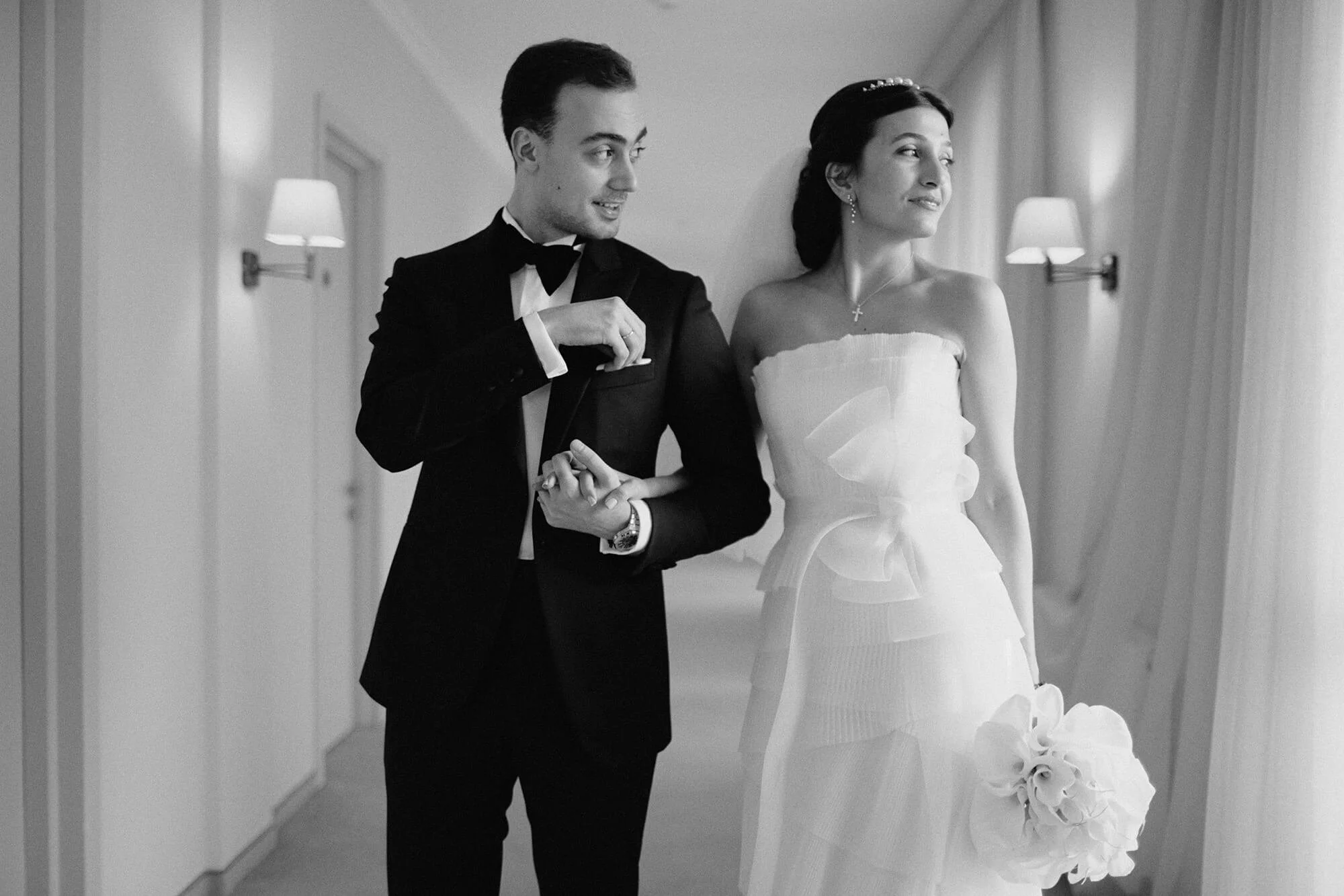 Black and white portrait of engaged couple in hotel hallway