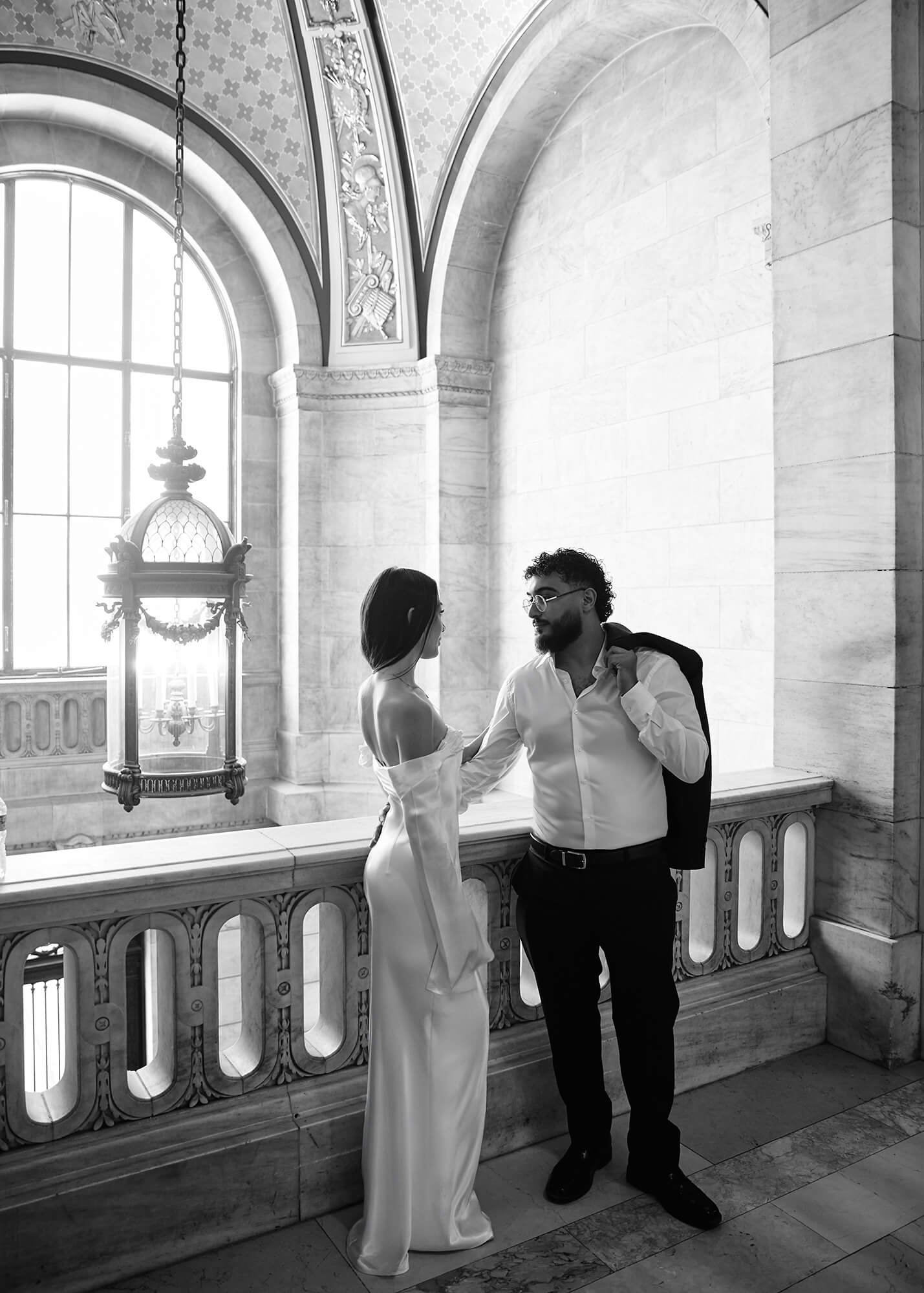Romantic moment of couple on New York Public Library steps during engagement shoot
