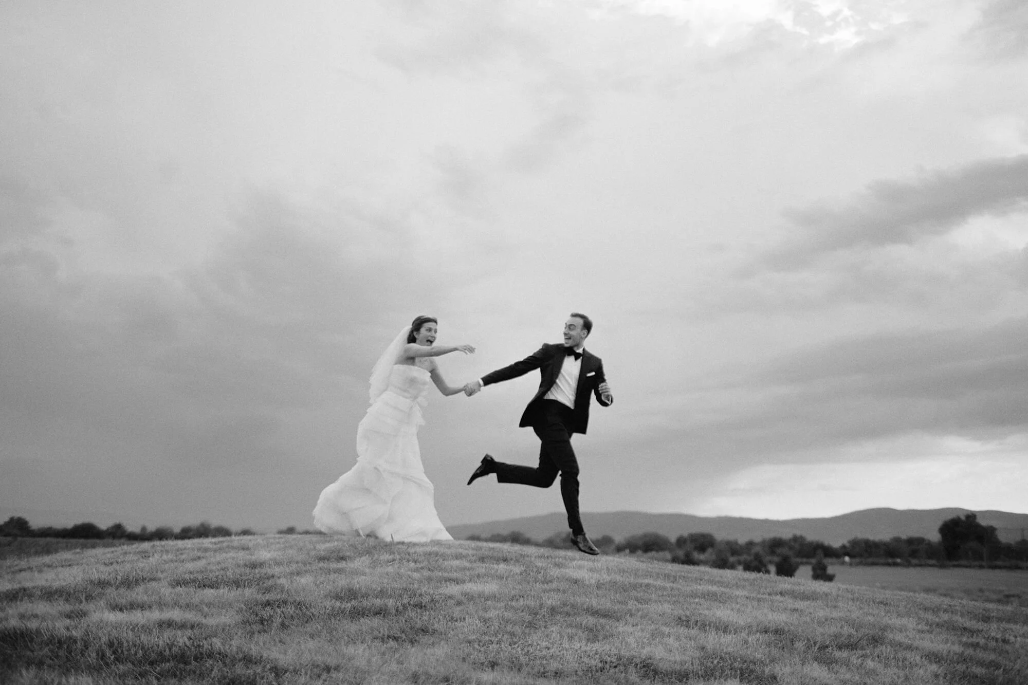 Joyful moment of couple jumping in golf field