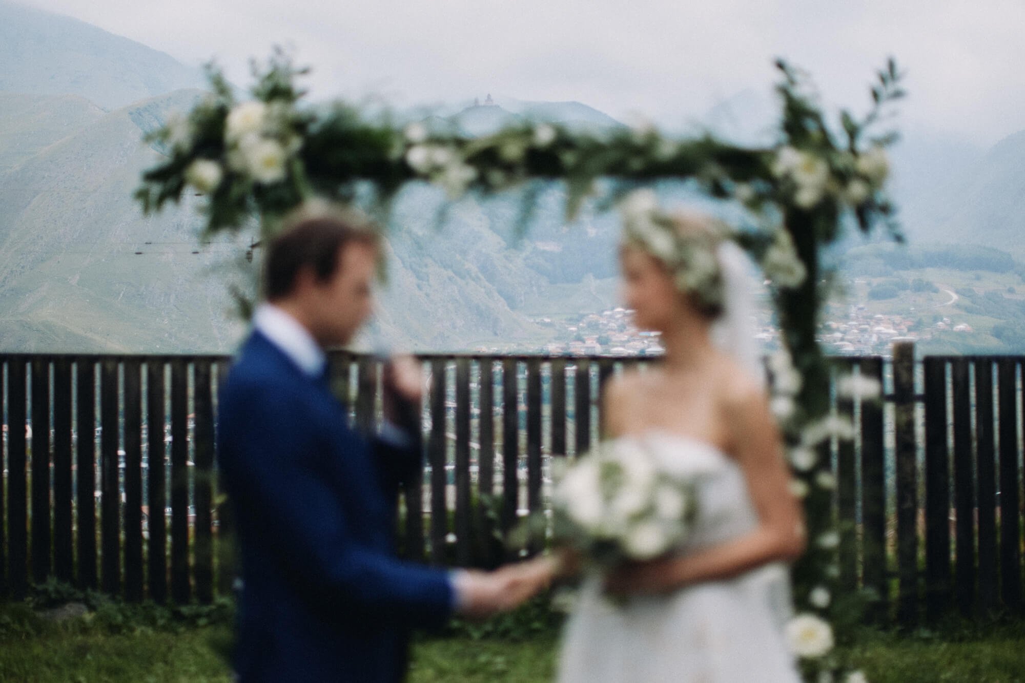 Groom holding bride’s hands during vows