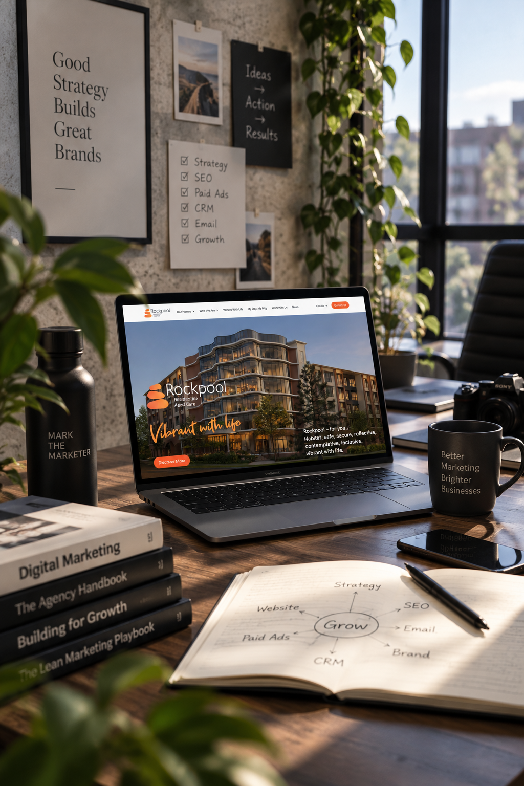 Laptop showing a website built for a care home client, beside a Grow strategy notebook