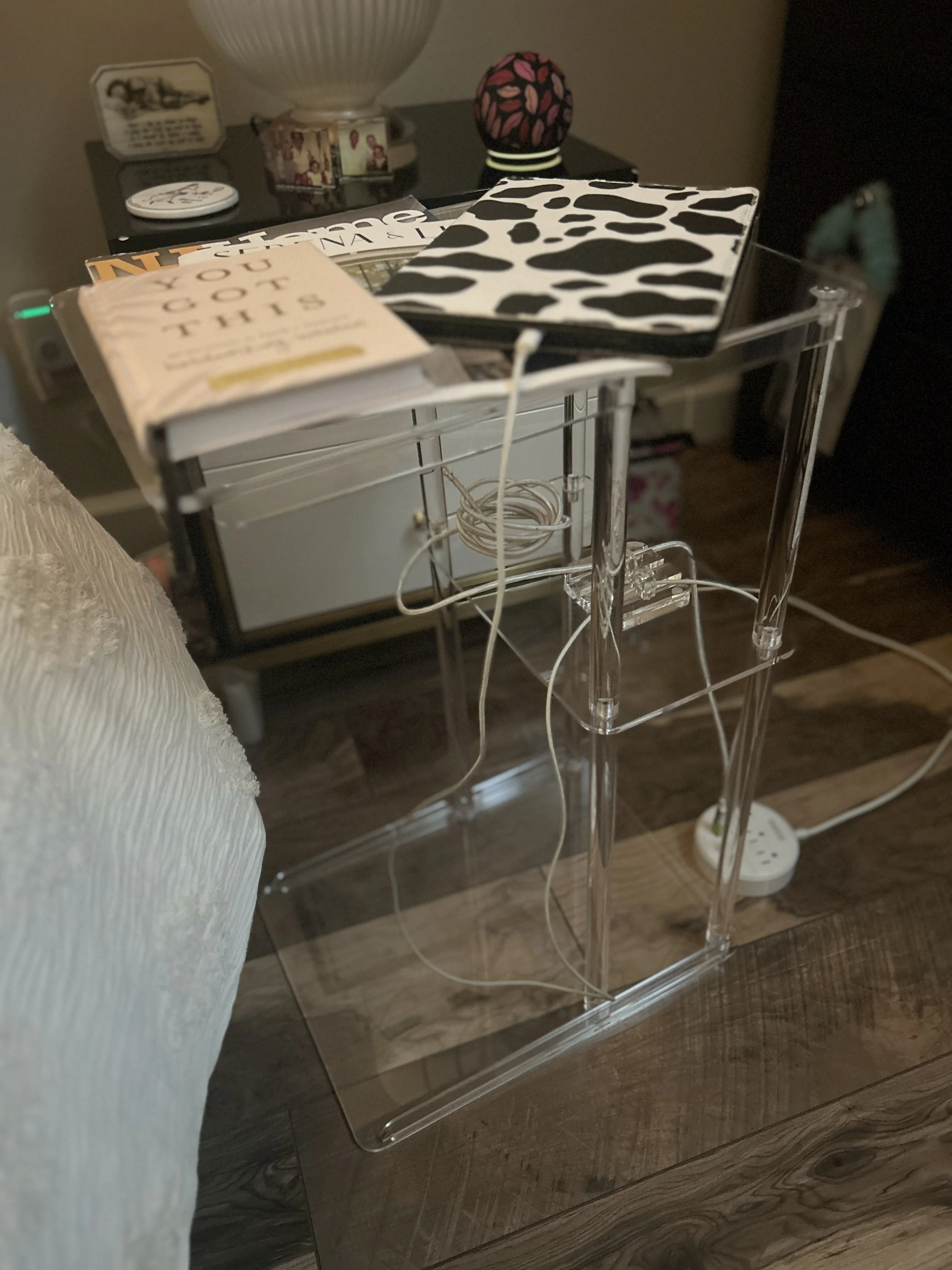 This acrylic bedside table supports books, technology, and everyday essentials while maintaining visual lightness.  Thoughtful organization helps everyday technology blend seamlessly into the design, preserving visual calm.