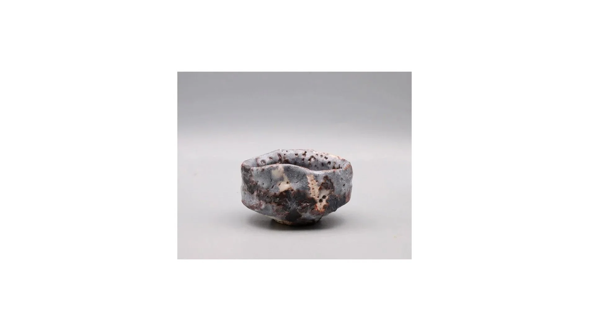 Seiki Kyoho. Clog-shaped Nezumi sake cups, hand-built stoneware, iron slip, white Shino glaze, H 4.7 cm x W 6.1 cm.