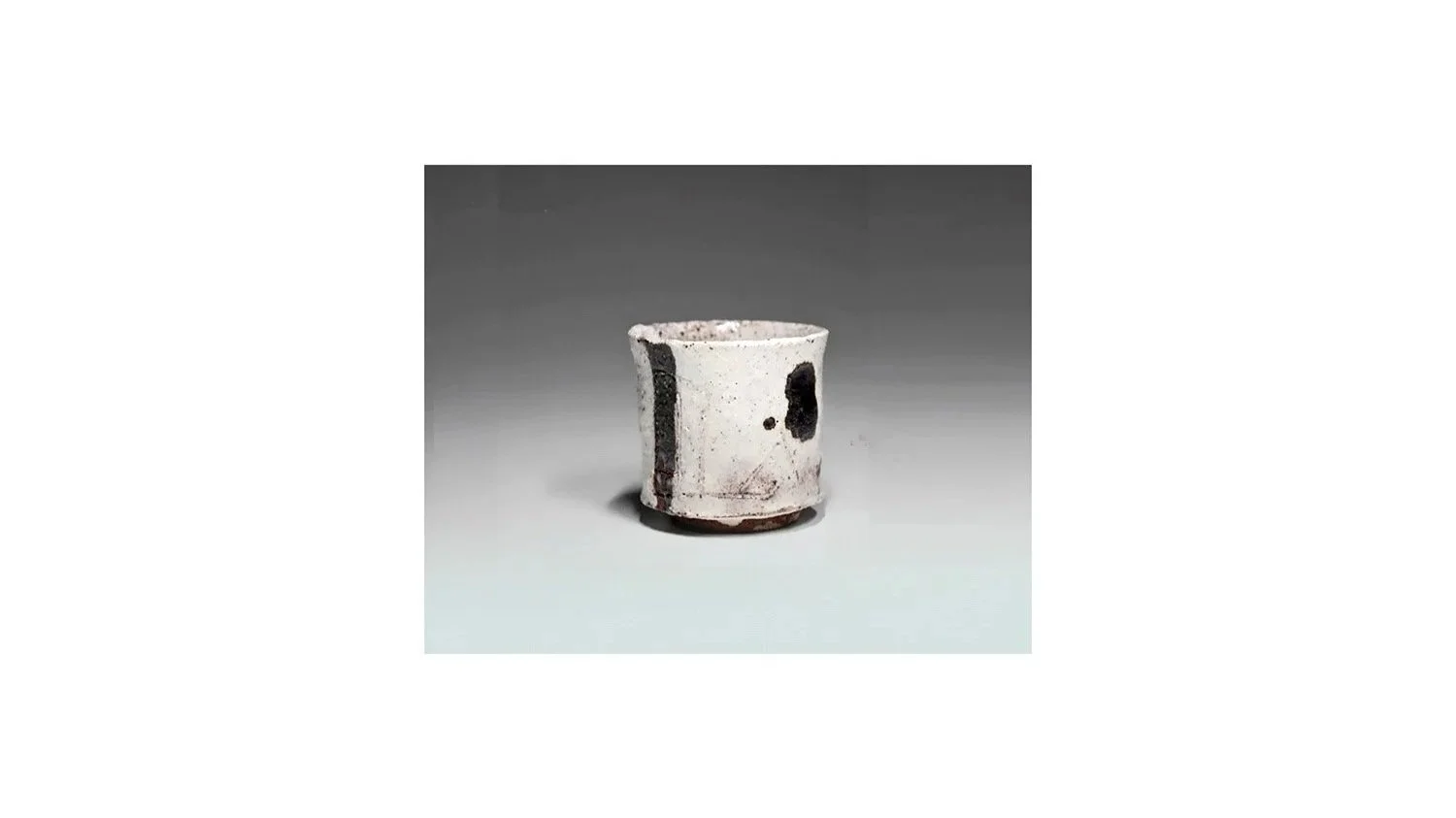 Koei Ryoji (1938-2000). White sake cup, stoneware with black iron-oxide glaze, H 5.3 cm x W 5.3 cm.
