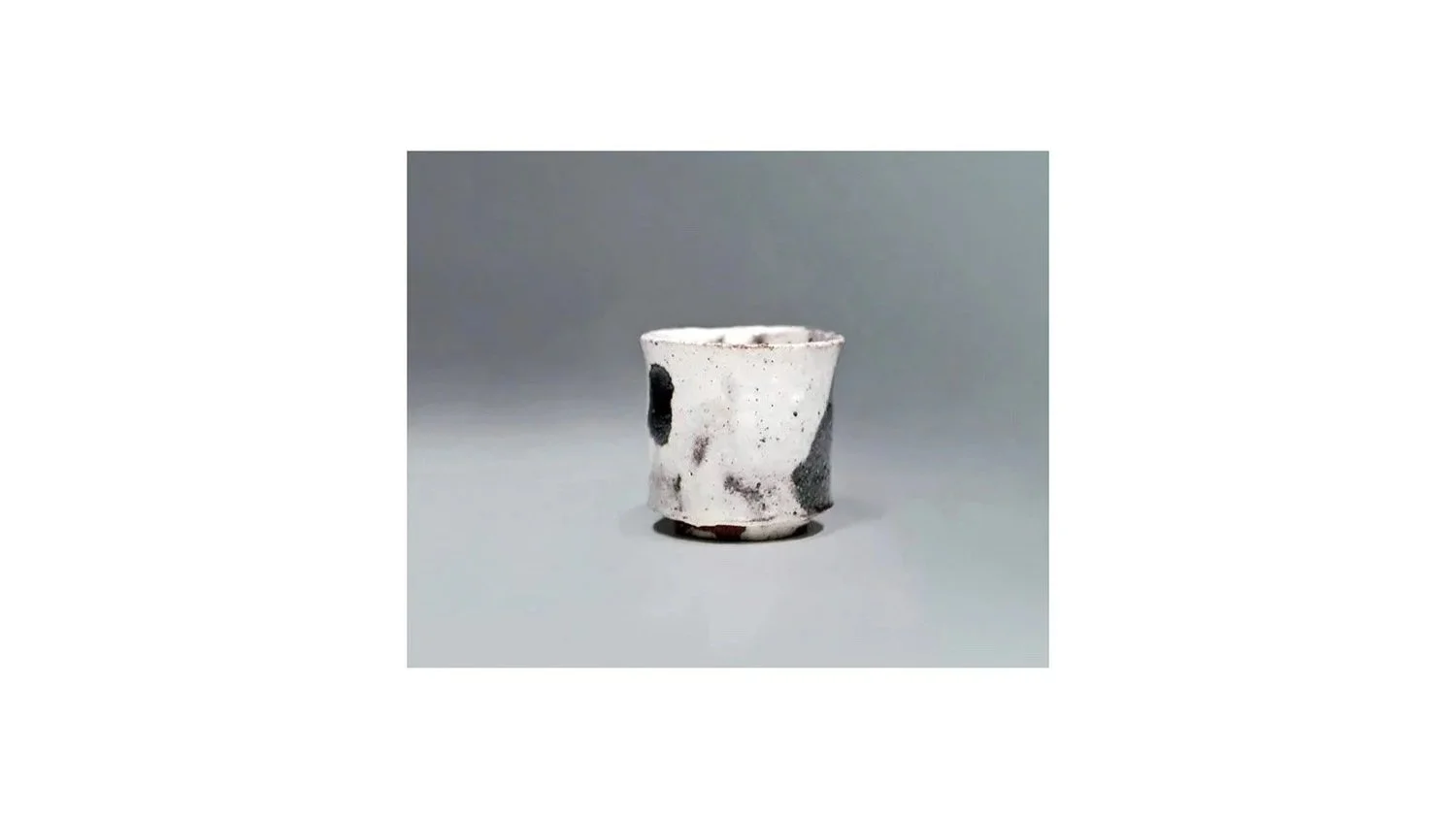 Koei Ryoji (1938-2000). White sake cup, stoneware with black iron-oxide glaze, H 5.3 cm x W 5.3 cm.