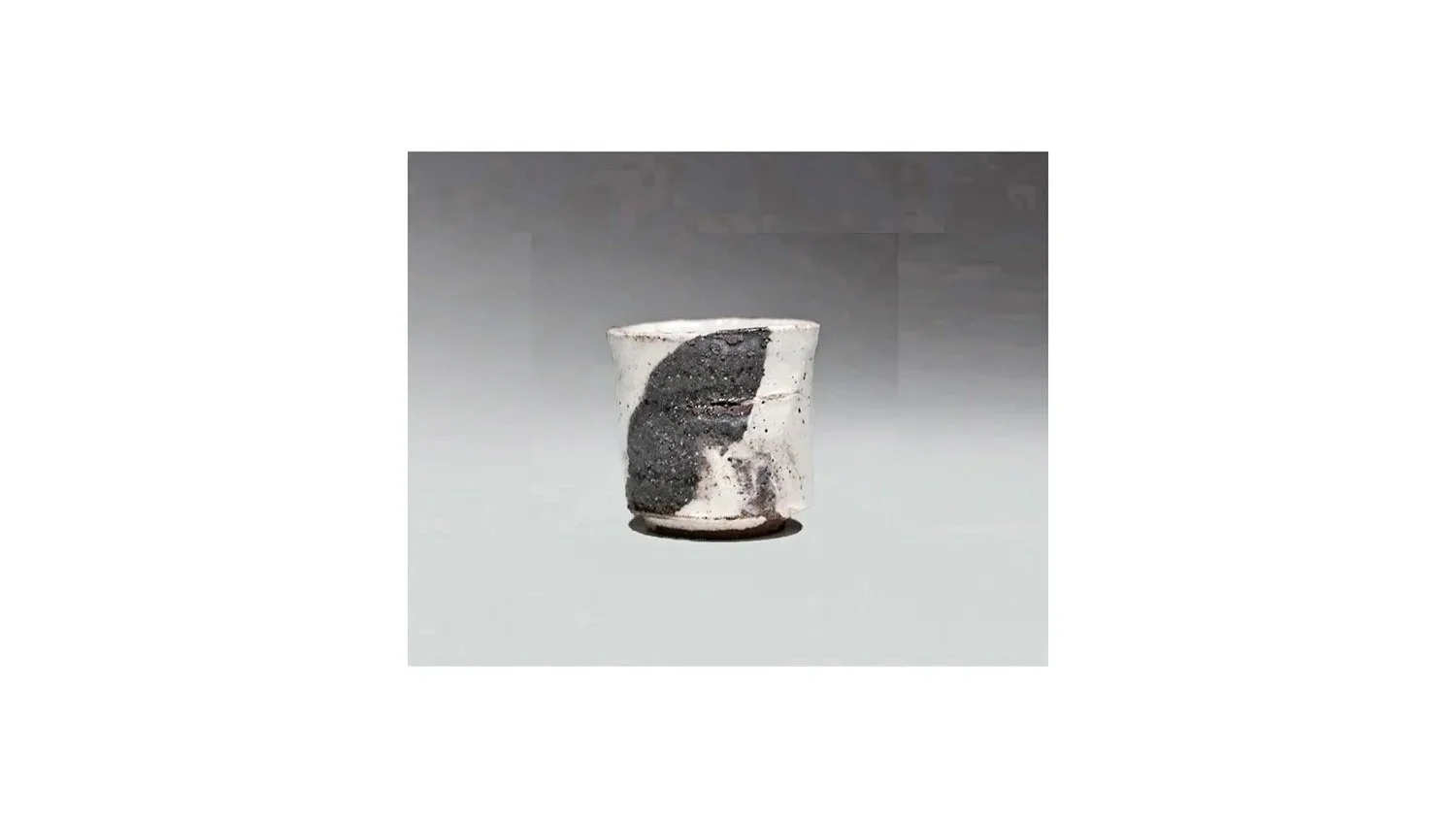 Koei Ryoji (1938-2000). White sake cup, stoneware with black iron-oxide glaze, H 5.3 cm x W 5.3 cm.