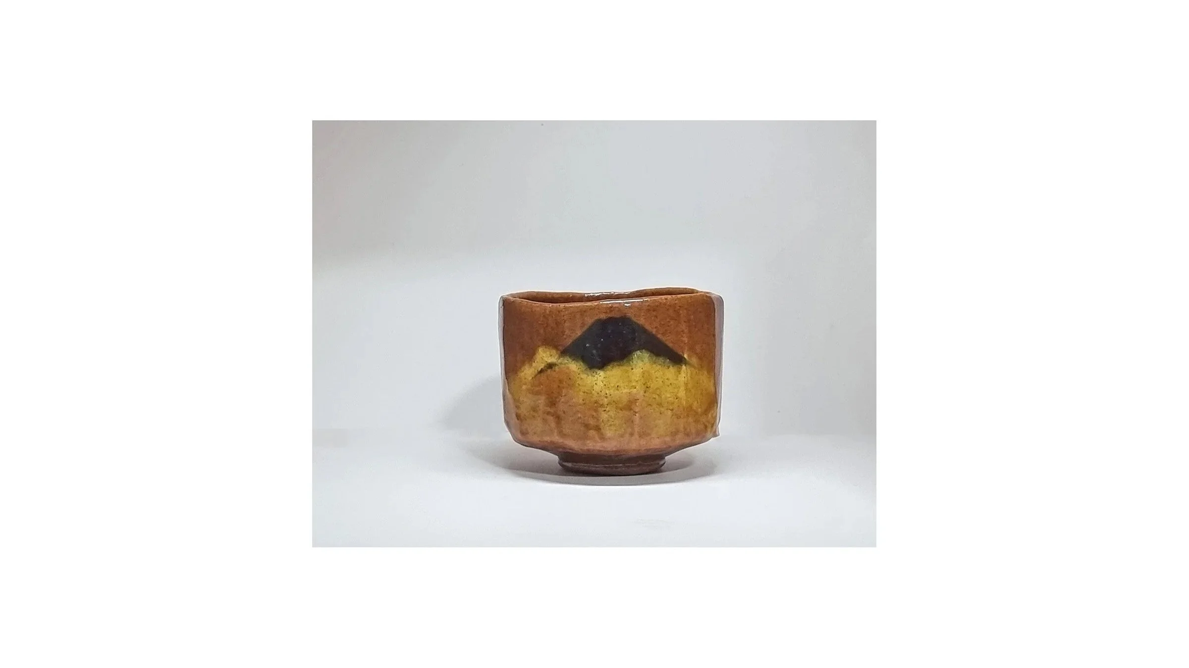 Sasaki Yamato (Sasaki Shoraku IV). Amber chawan with Mt Fuji scenery, Raku ware, H 8.5 cm x W 11.5 cm. 