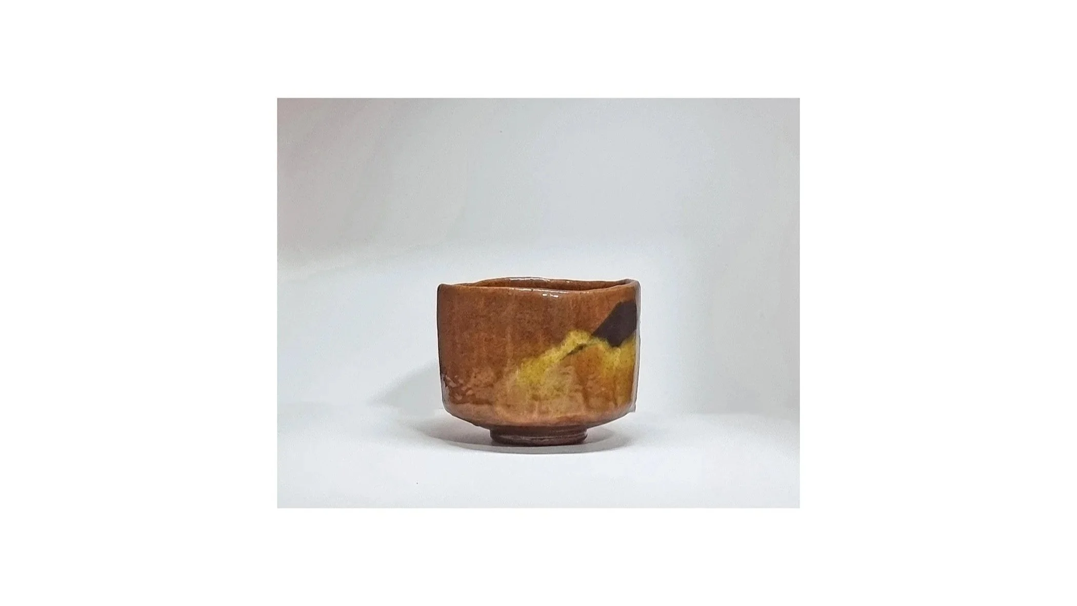 Sasaki Yamato (Sasaki Shoraku IV). Amber chawan with Mt Fuji scenery, Raku ware, H 8.5 cm x W 11.5 cm. 