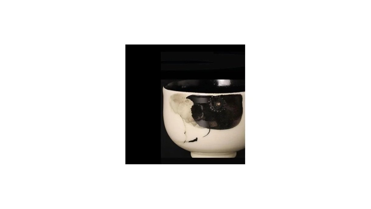Kazu Yoneda (b. 1949). Black-painted tea bowl with lotus plant motif, porcelain, H 7.5 cm x W 10 cm. 