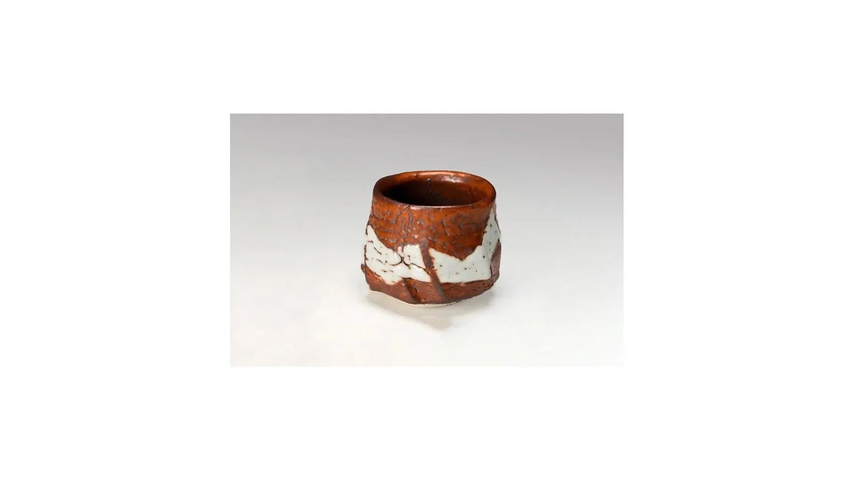 Suzuki Tomio (b. 1948). Red Shino sake cup, H 6 cm x W 7.5 cm. 