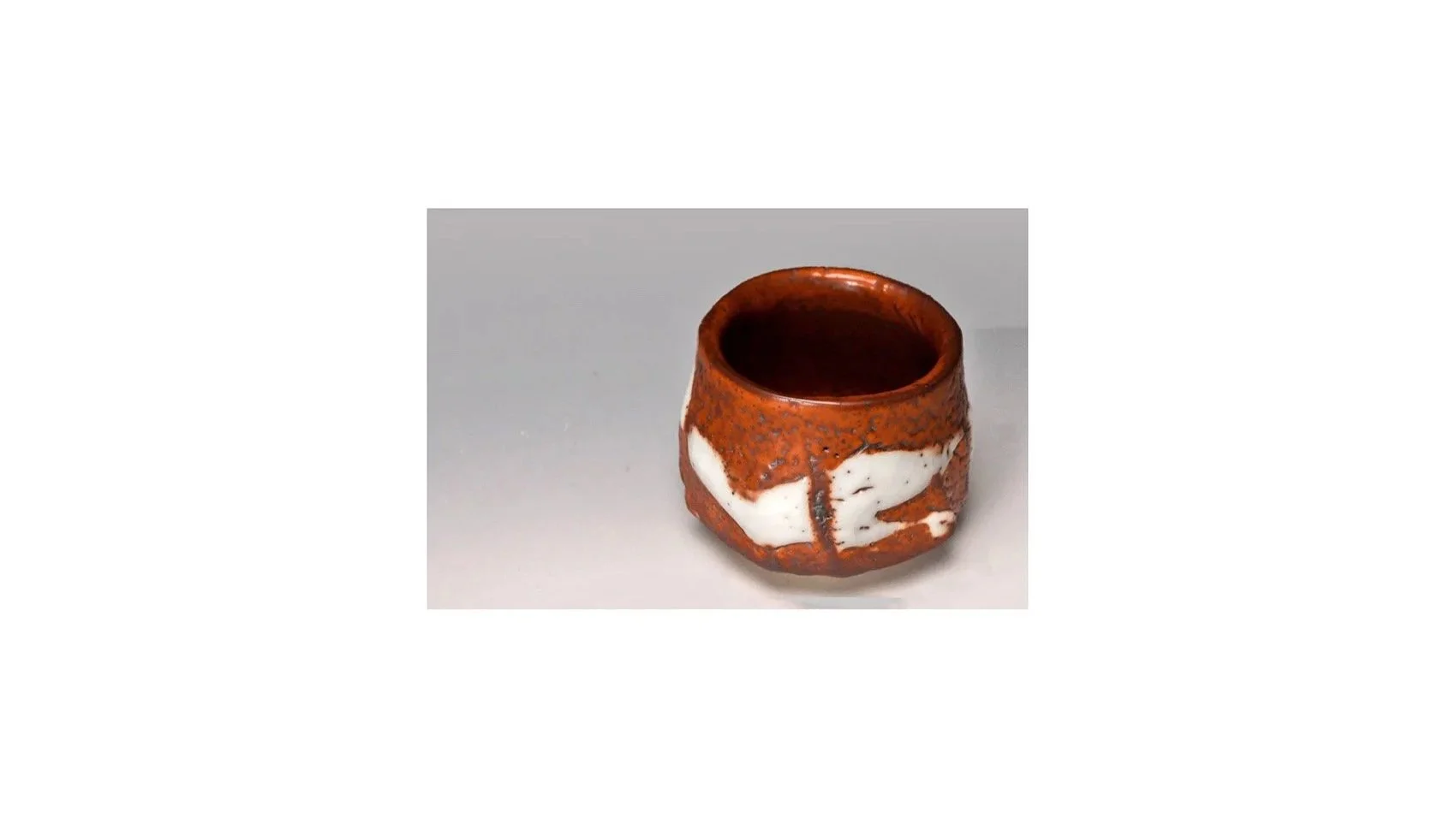 Suzuki Tomio (b. 1948). Red Shino sake cup, H 6 cm x W 7.5 cm. 