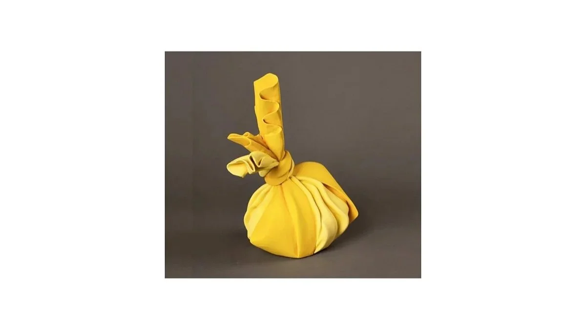 Tanaka Yu (b. 1989), Sculpture in the form of a wrapped bundle from the ‘Tsutsumimono’ series, coil-built stoneware with yellow slip, H 26 cm x W 21 cm x D 15 cm. 