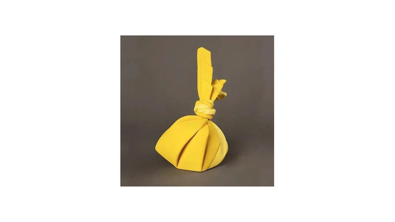 Tanaka Yu (b. 1989), Sculpture in the form of a wrapped bundle from the ‘Tsutsumimono’ series, coil-built stoneware with yellow slip, H 26 cm x W 21 cm x D 15 cm. 