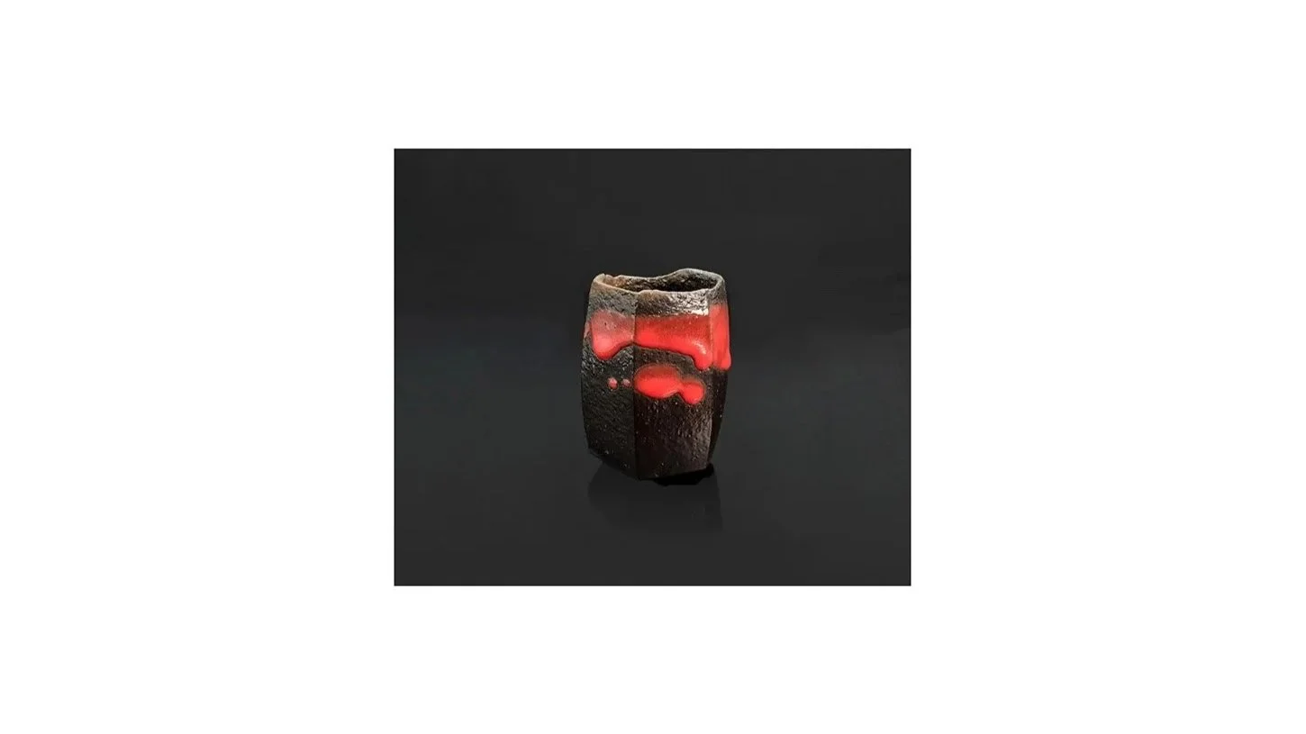 Takenaka Kenji, angular faceted sake cup with vivid red glaze drips, charcoal wood-fired, H 10 cm x W 7 cm. 