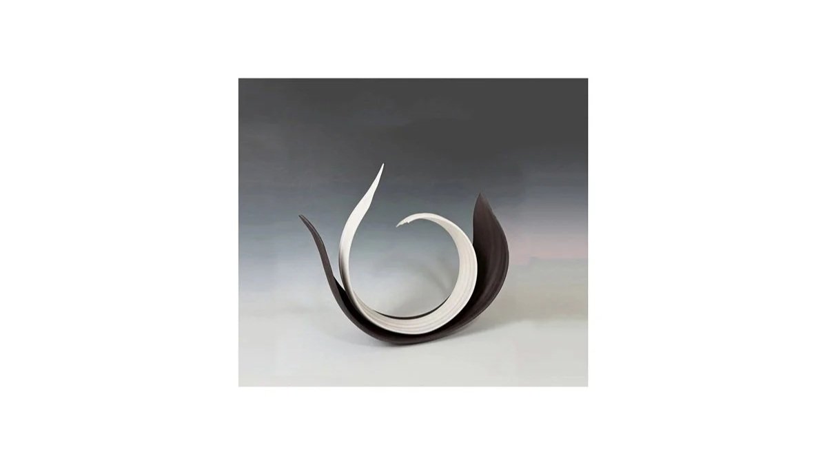 Yoshimura Atsuko, Curled sculpture entitled “Echo of a Circle”, from her “Black and White” series, wheel-thrown and hand-carved white porcelain and black stoneware, H 36 cm x W 36 cm x D 14 cm.