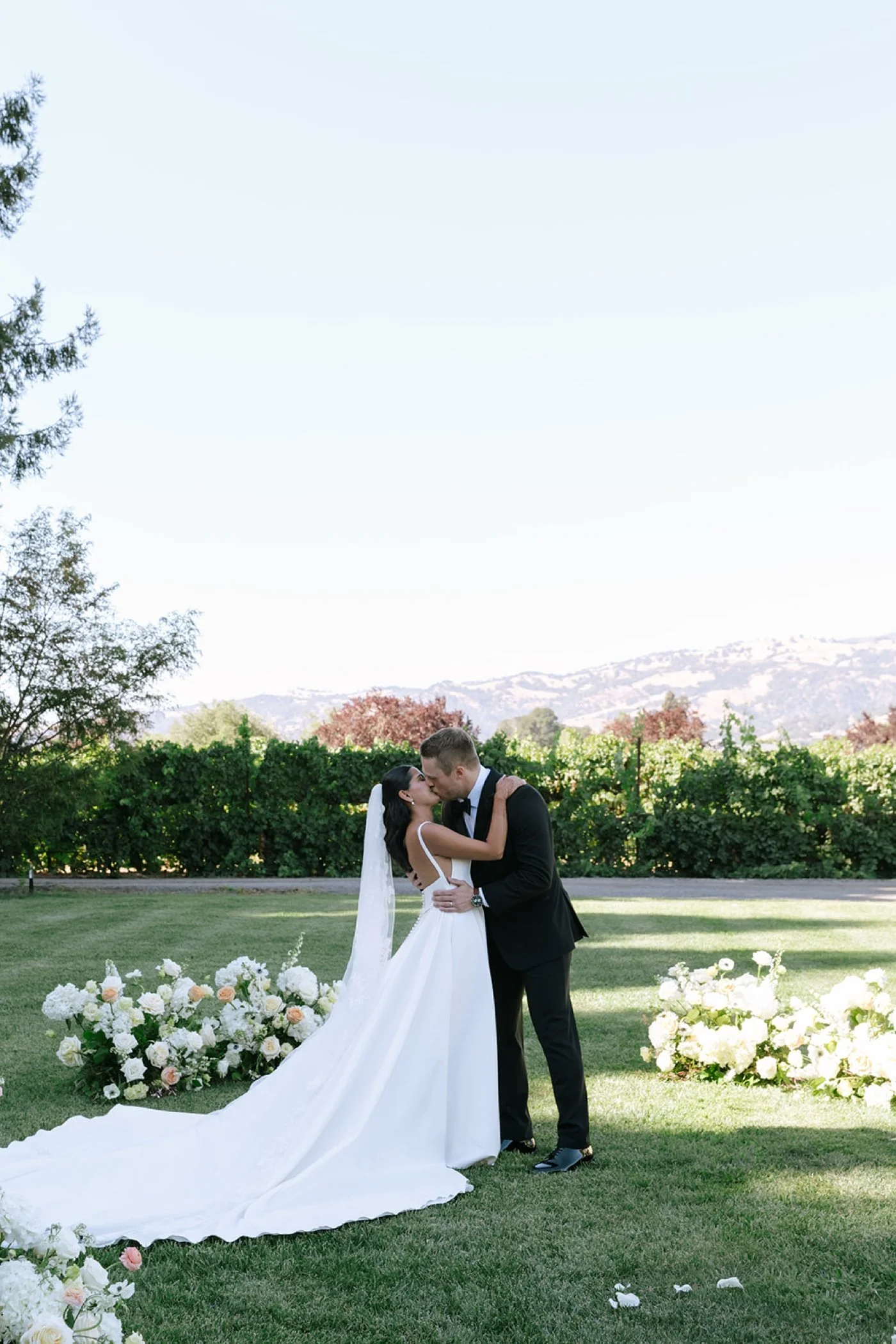 Bride and groom kissing at the end of their wedding ceremony