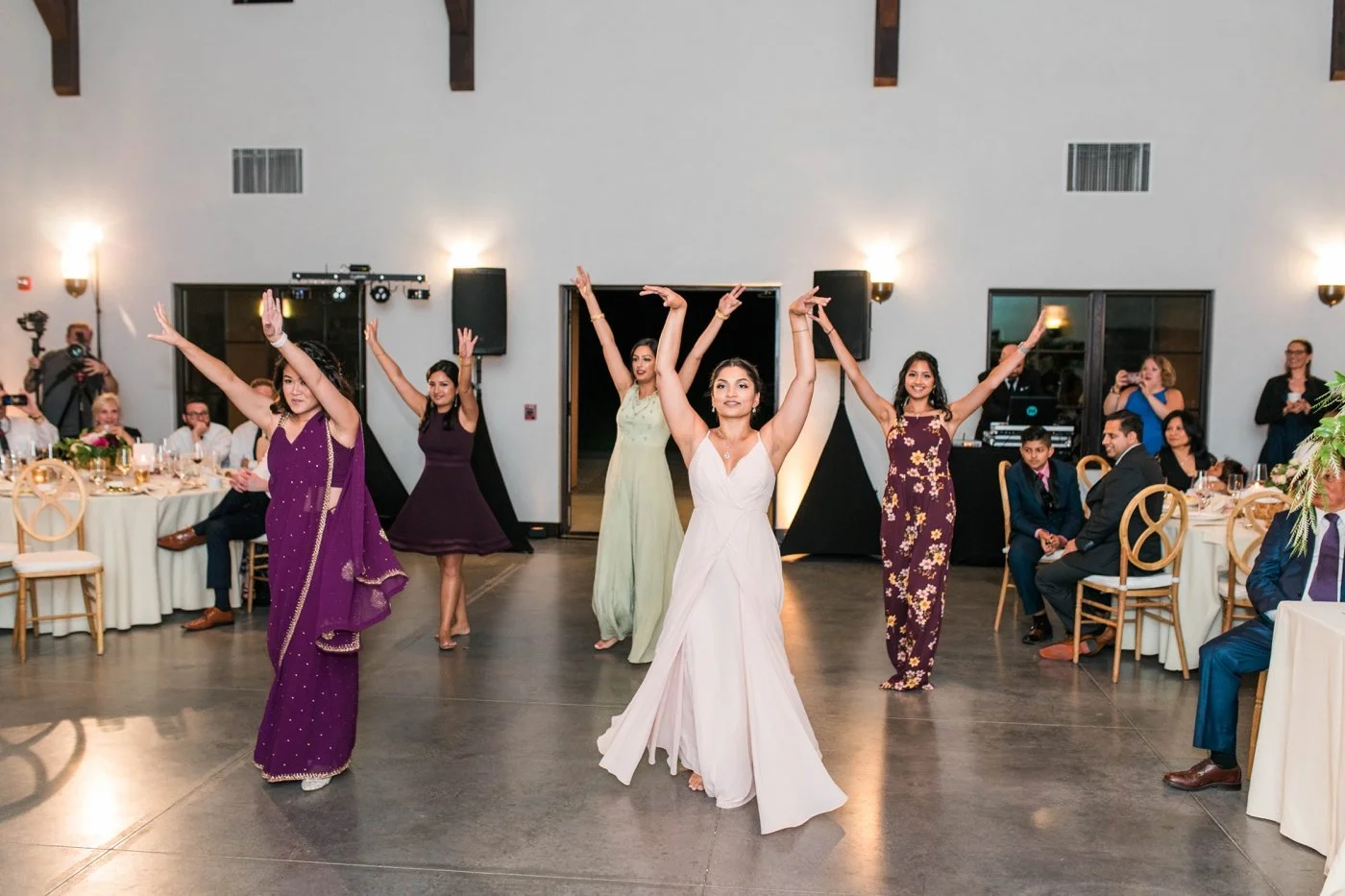 Women performing a traditional Indian dance at a wedding reception