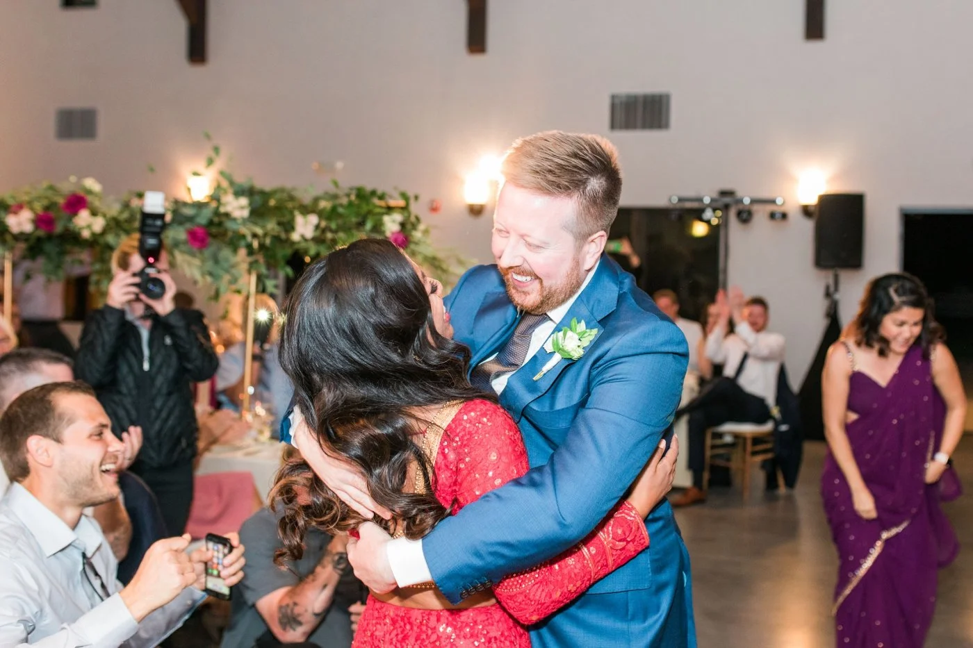 Bride hugging her groom at their wedding reception