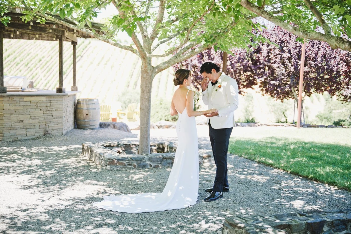 Groom wiping away tears after the first look on his wedding day