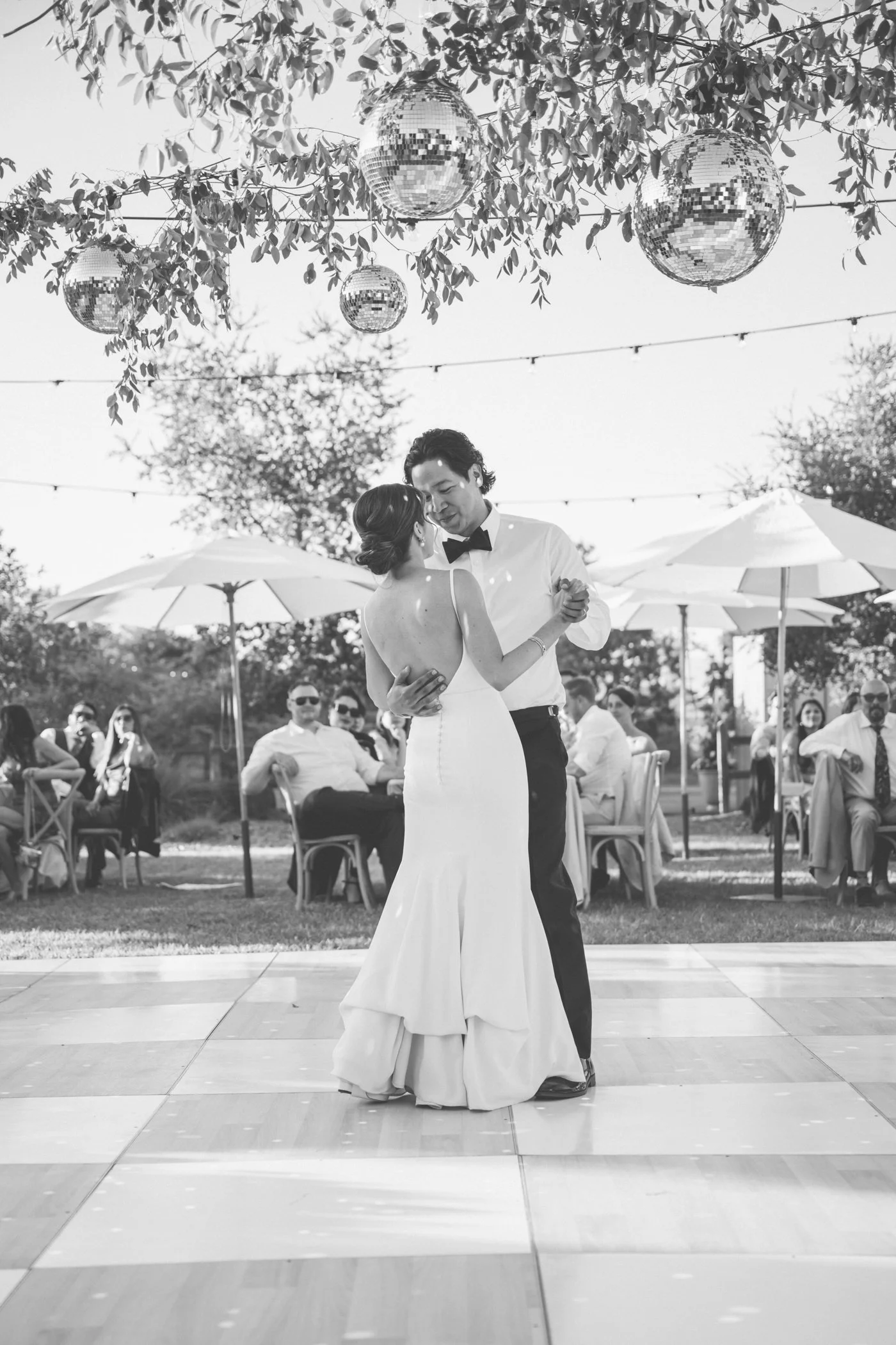 Bride and groom dancing under disco balls