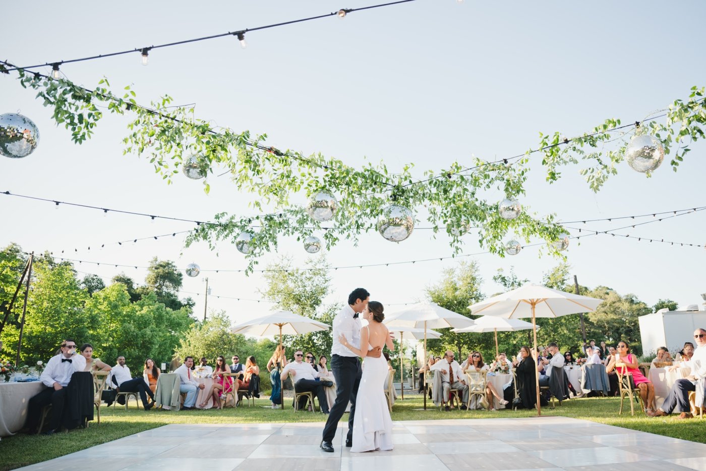 Bride and groom dancing under disco balls
