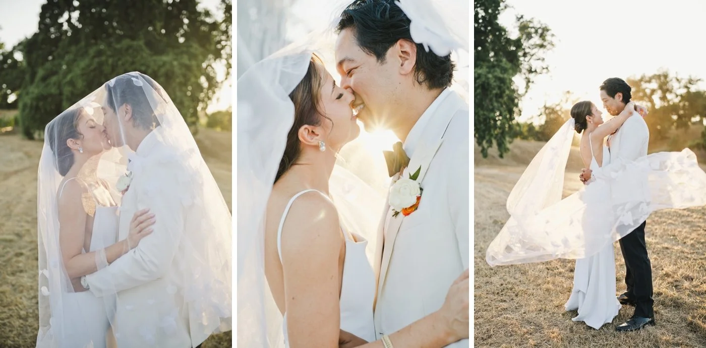 Bride and groom kissing under a veil