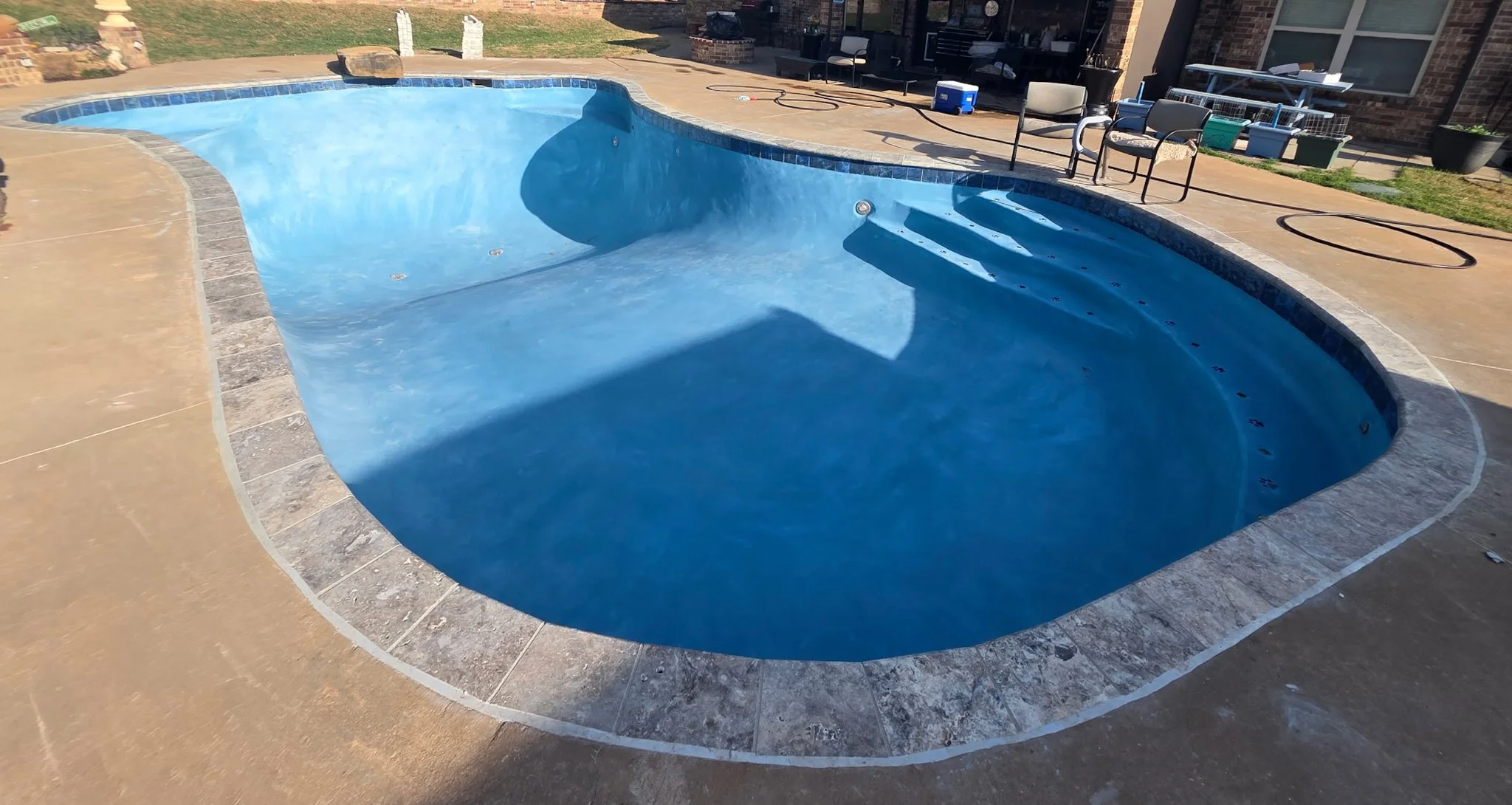 Remodeled Pool with Taho Blue 100% Quartz plaster and Mica Accents, new coping with new 6x6 tile, and grey mastics in Guthrie OK