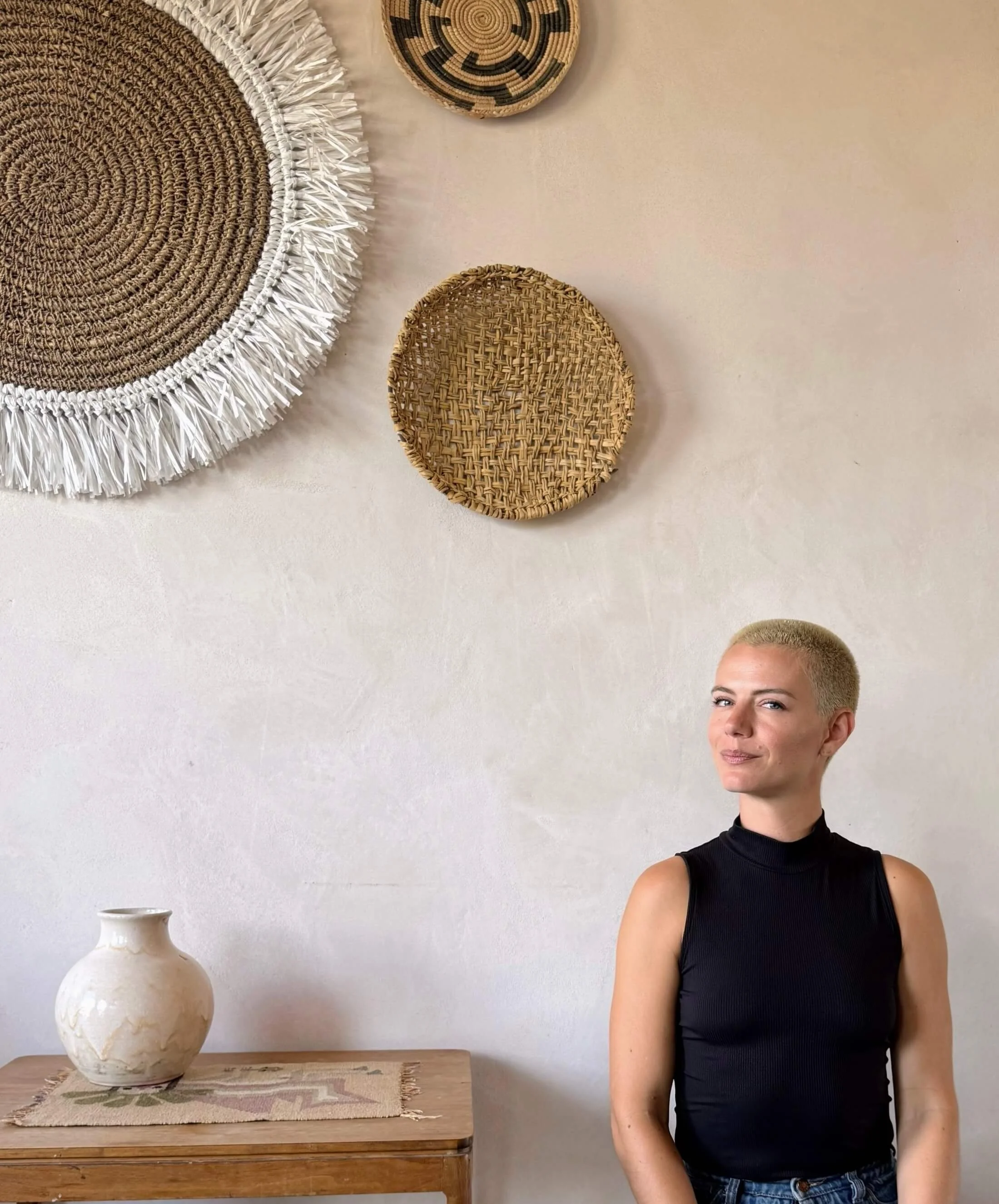 Female practitioner standing in a calm wellness studio environment promoting mind body connection therapy
