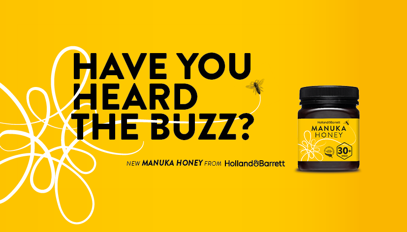 Yellow advertisement for Holland & Barrett Manuka Honey with a jar of honey on the right and a bee flying near a line drawing of a bee on the left, with the text 'Have you heard the buzz?'